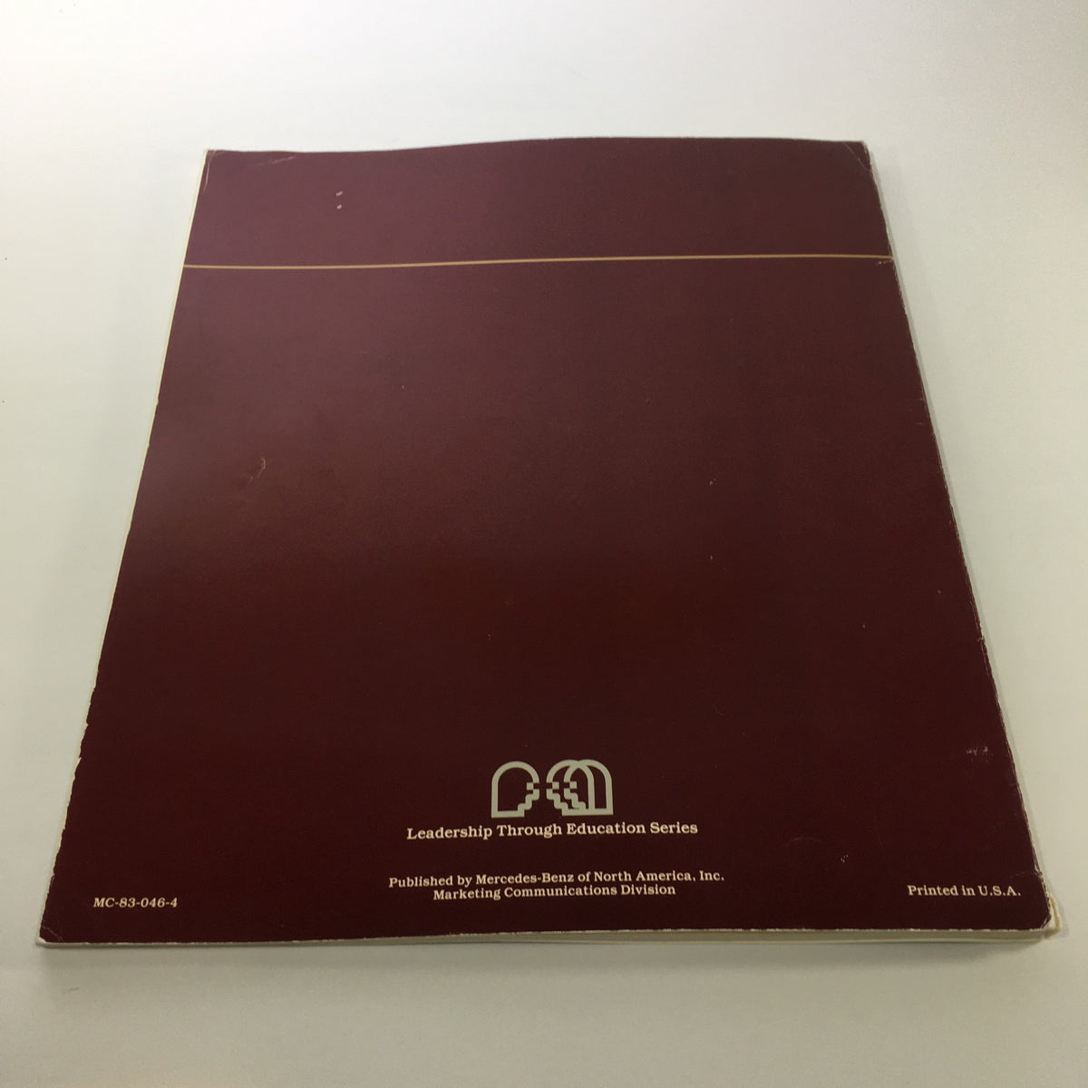 Back cover of the 1984 Mercedes-Benz 190-Class Product and Sales Information Catalog, displaying the Leadership Through Education Series emblem.