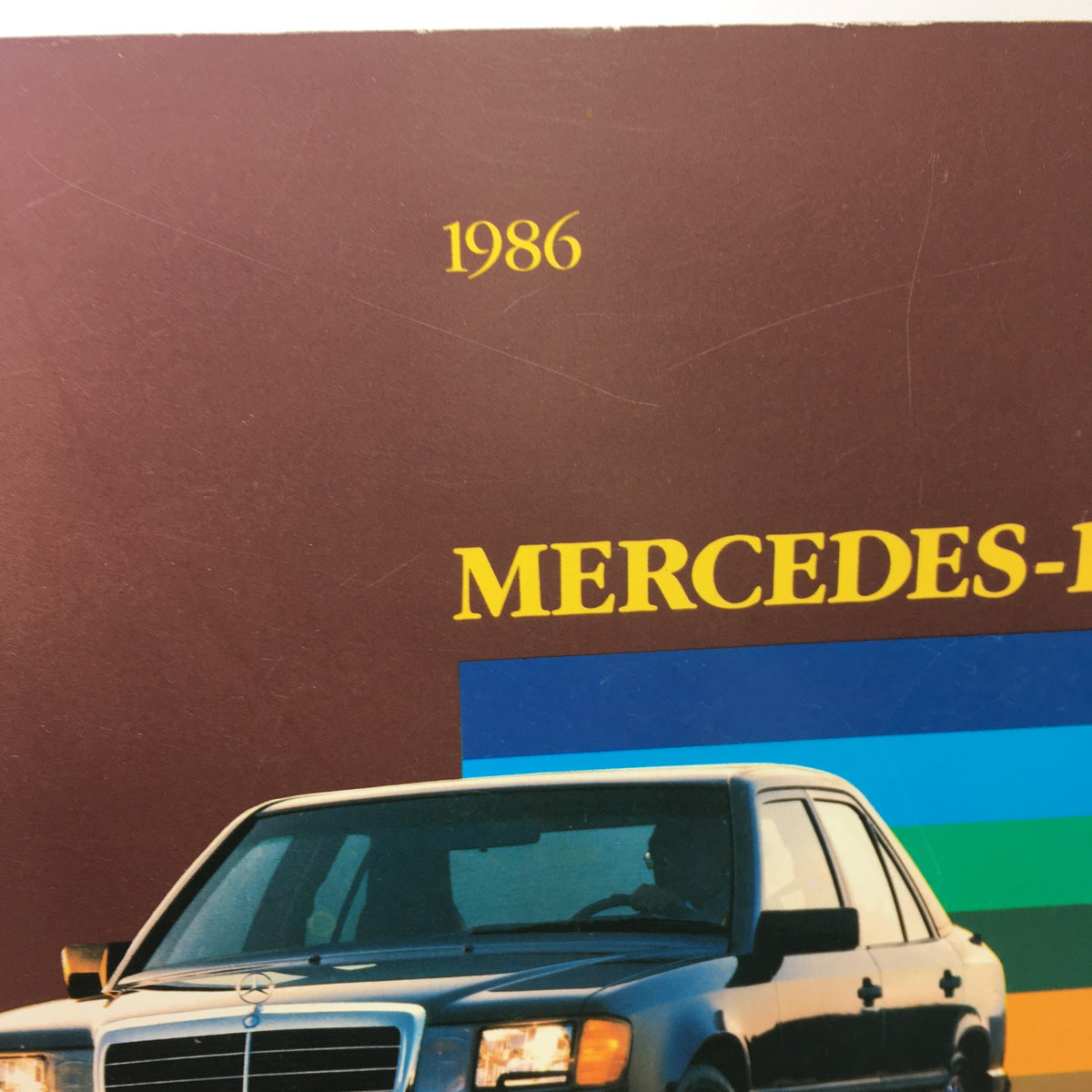Close-up of the 1986 Mercedes-Benz Product and Sales Information Brochure title featuring the brand name in bold text.
