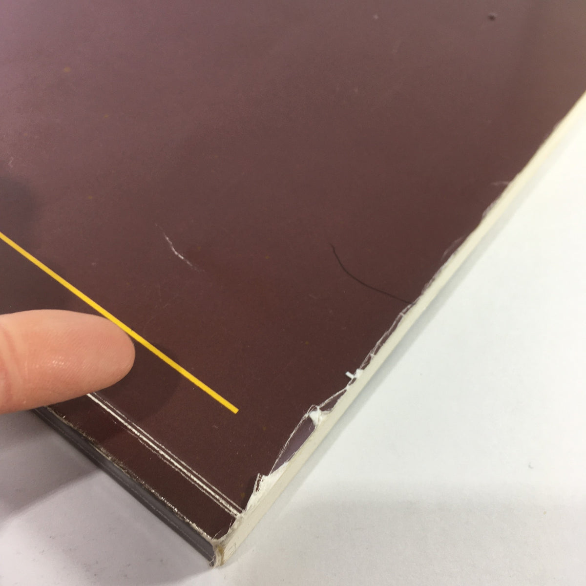 Close-up of the upper edge of the 1986 Mercedes-Benz Product and Sales Information Brochure indicating wear.