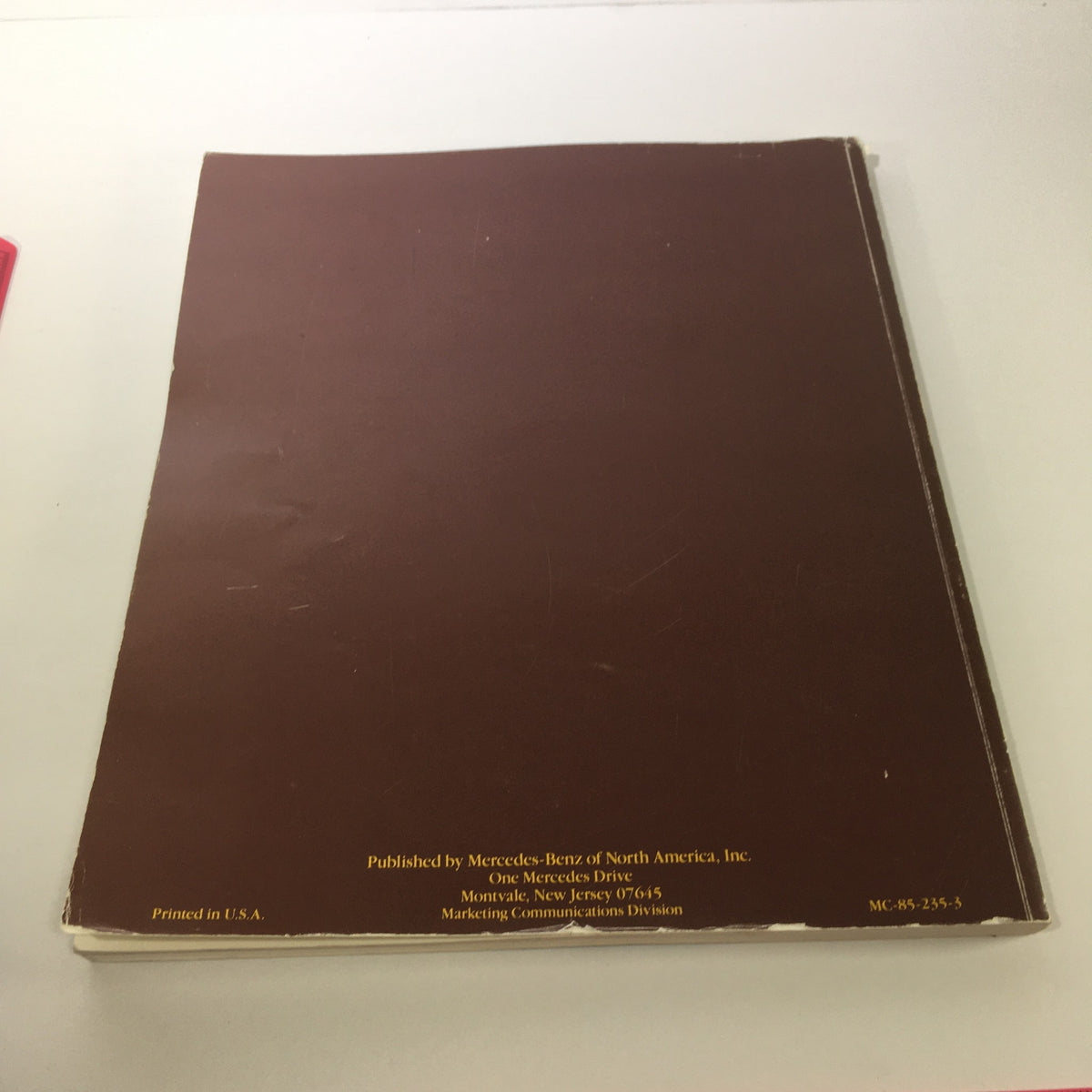 Back cover of the 1986 Mercedes-Benz Product and Sales Information Brochure, featuring a simple brown design with text detailing publication information and printing specifications.
