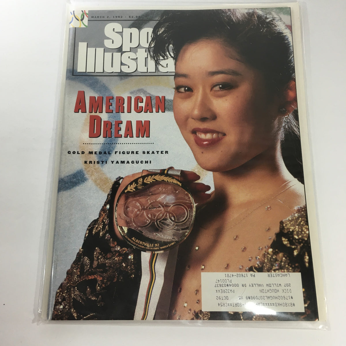 Cover of Sports Illustrated March 2, 1992 featuring gold medal figure skater Kristi Yamaguchi, showcasing her winning smile and the Olympic medal she won, with the title 'American Dream' prominently displayed.
