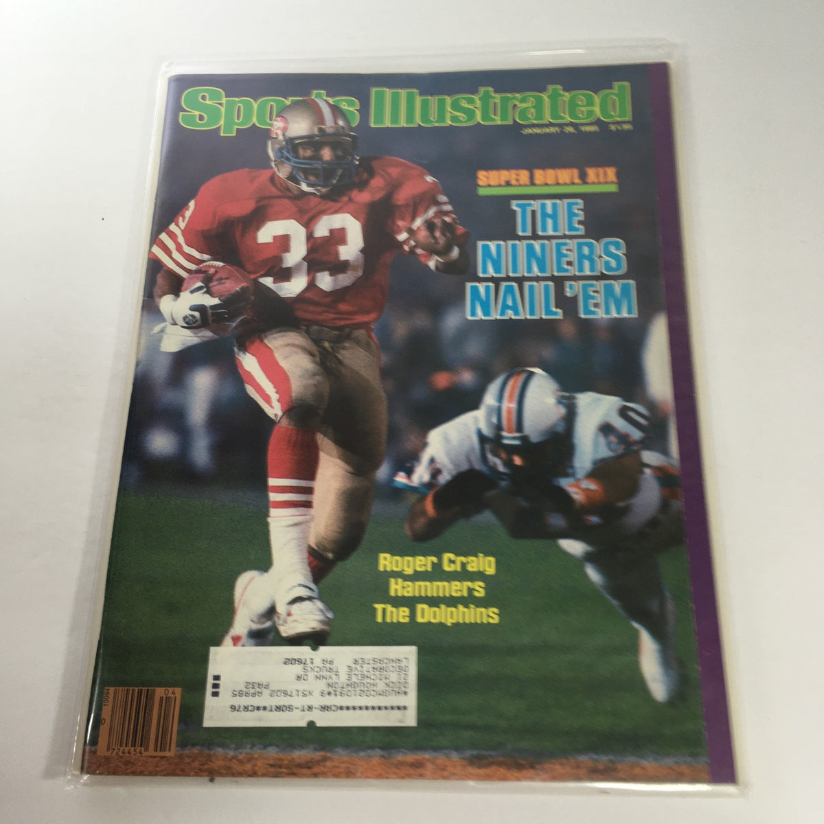 Cover of Sports Illustrated magazine from January 28, 1985, featuring Super Bowl XIX titled 'The Niner's Nail 'Em'. Showcases a football player in a red jersey with number 33 in action against opposing players. The magazine highlights Roger Craig's performance against the Dolphins.