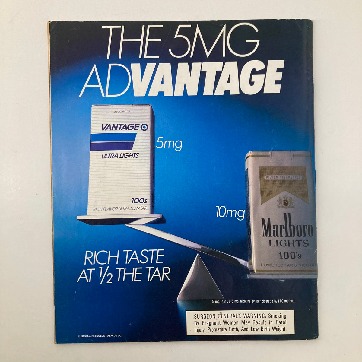 Cover of the vintage advertisement for Vantage and Marlboro Lights cigarettes, featuring a blue background and text emphasizing a reduced tar content, linked to the VTG Memories Magazine of Then and Now, August 1989.