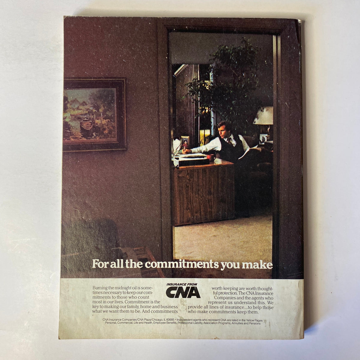 Back cover of Forbes Magazine Fall 1983 featuring an imagery of a man working in an office. The text mentions 'For all the commitments you make' and advertises insurance from CNA.
