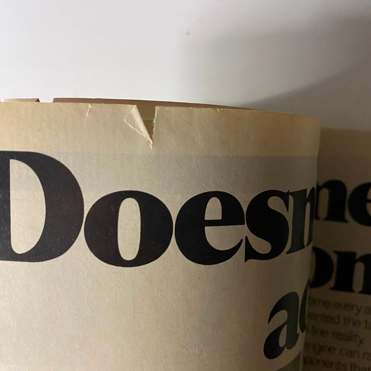 Detail of the chipped top edge of the April 28, 1980 Forbes Magazine, indicating age-related wear.