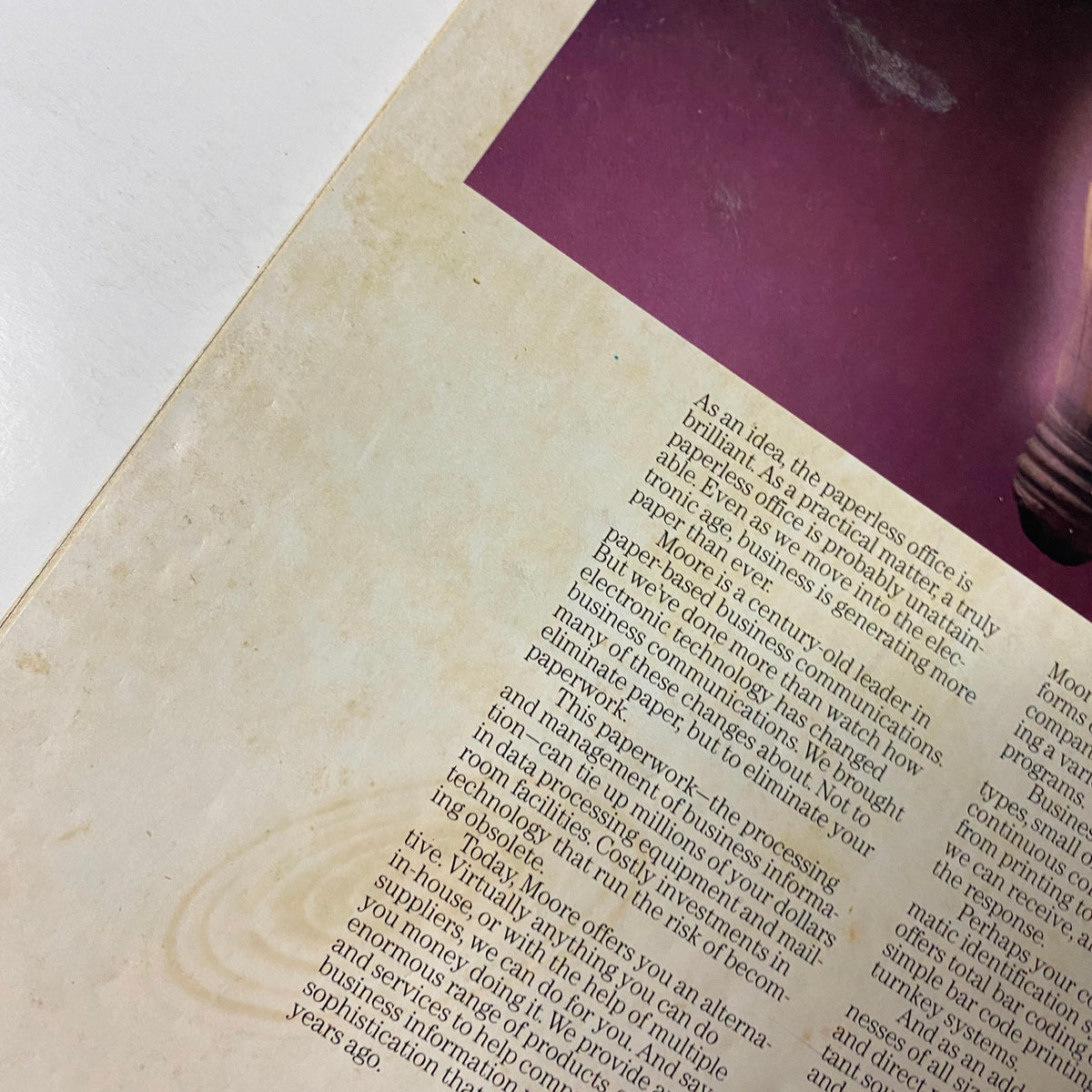 Close-up view of the back cover of Forbes Magazine July 14, 1986, discussing the inefficiencies of paperwork in business and promoting Moore's services for improved management.