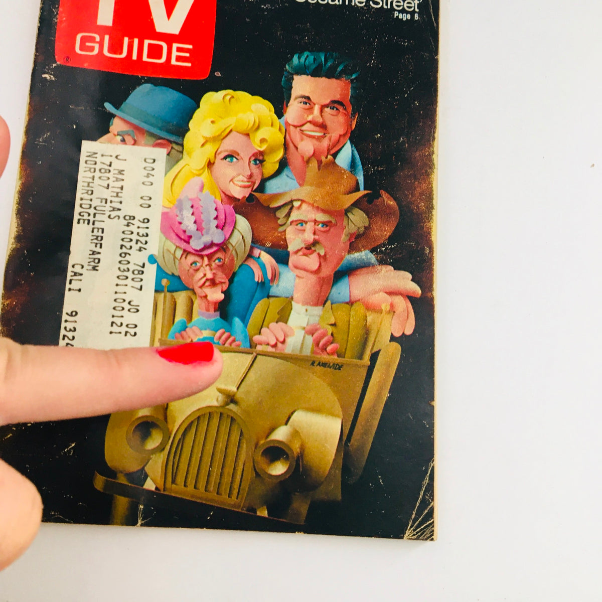 Close-up view of the July 11, 1970, Vol 18 #28 TV Guide cover, showcasing cartoon characters in a car and the iconic TV Guide logo. The image emphasizes the nostalgic charm of television history and the address label on the front.