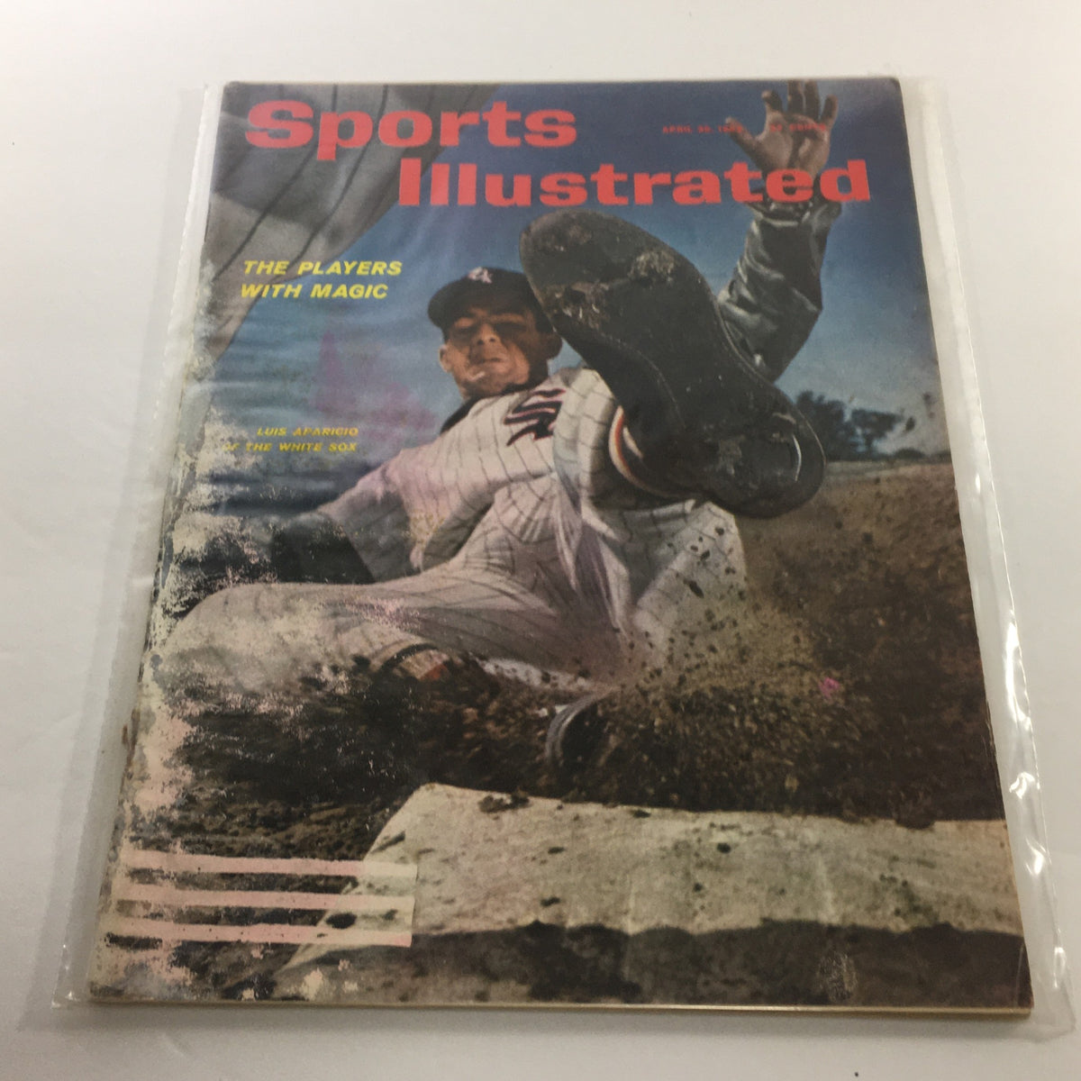 Cover of Sports Illustrated: April 30, 1962 - The Players With Magic featuring Luis Aparicio sliding into home plate, showcasing vintage baseball imagery.