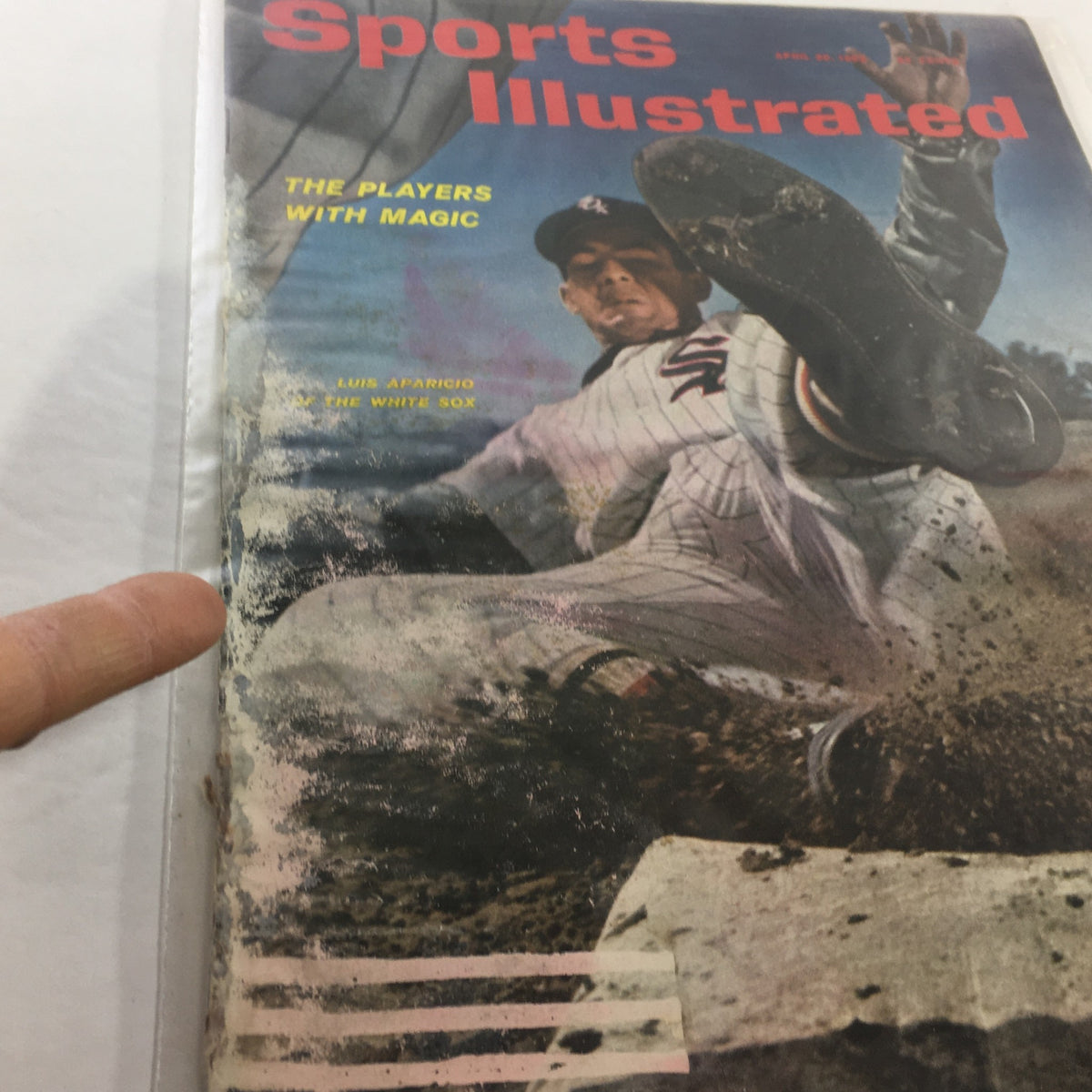 Detailed view of the Sports Illustrated: April 30, 1962 cover, highlighting Luis Aparicio in action, illustrating the excitement of baseball from the 1960s.