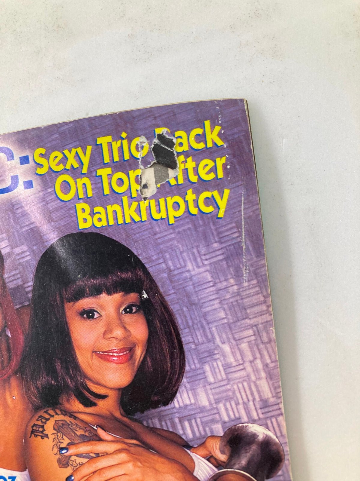 Close-up of the Jet Magazine cover from April 12, 1999 displaying the text 'TLC: Sexy Trio Back On Top After Bankruptcy' with an image of Drew Sidora, highlighting the magazine's focus on pop culture.