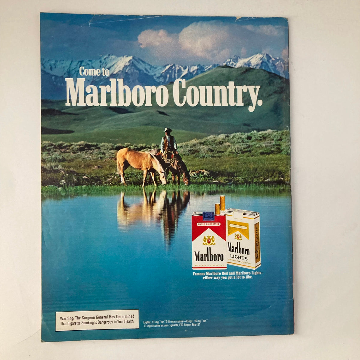 Vintage advertisement from March 1982 VTG Life Magazine for Marlboro cigarettes, featuring scenic 'Marlboro Country' landscape with cowboy and horse.