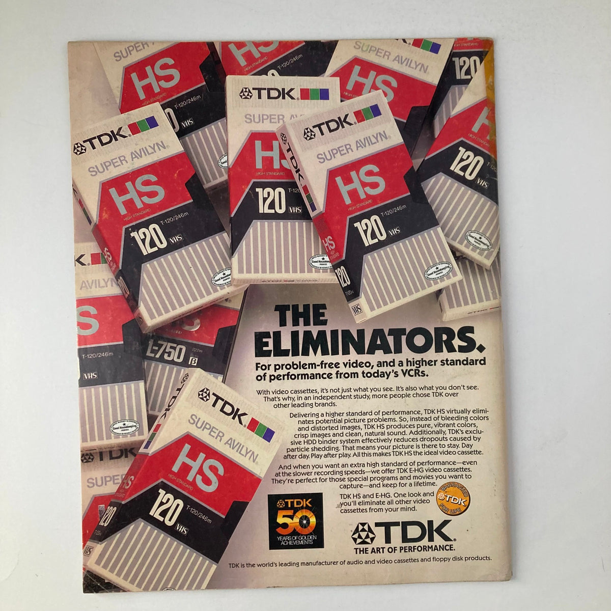 Advertisement for TDK VHS tapes showcasing the phrase 'The Eliminators' with multiple video cassette boxes; title: VTG Life Magazine December 1986 Vol 9 No. 13 Madonna and The Camera.