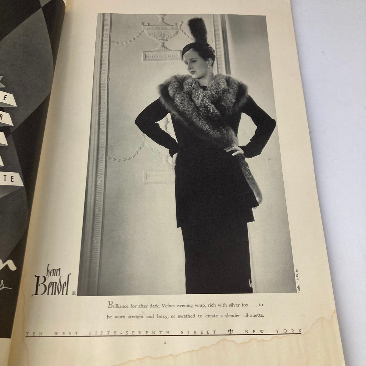 Fashion advertisement from the Vintage Stage Magazine November 1937 featuring a model in a luxurious velvet evening wrap designed by Henri Bendel, emphasizing its elegant styling.