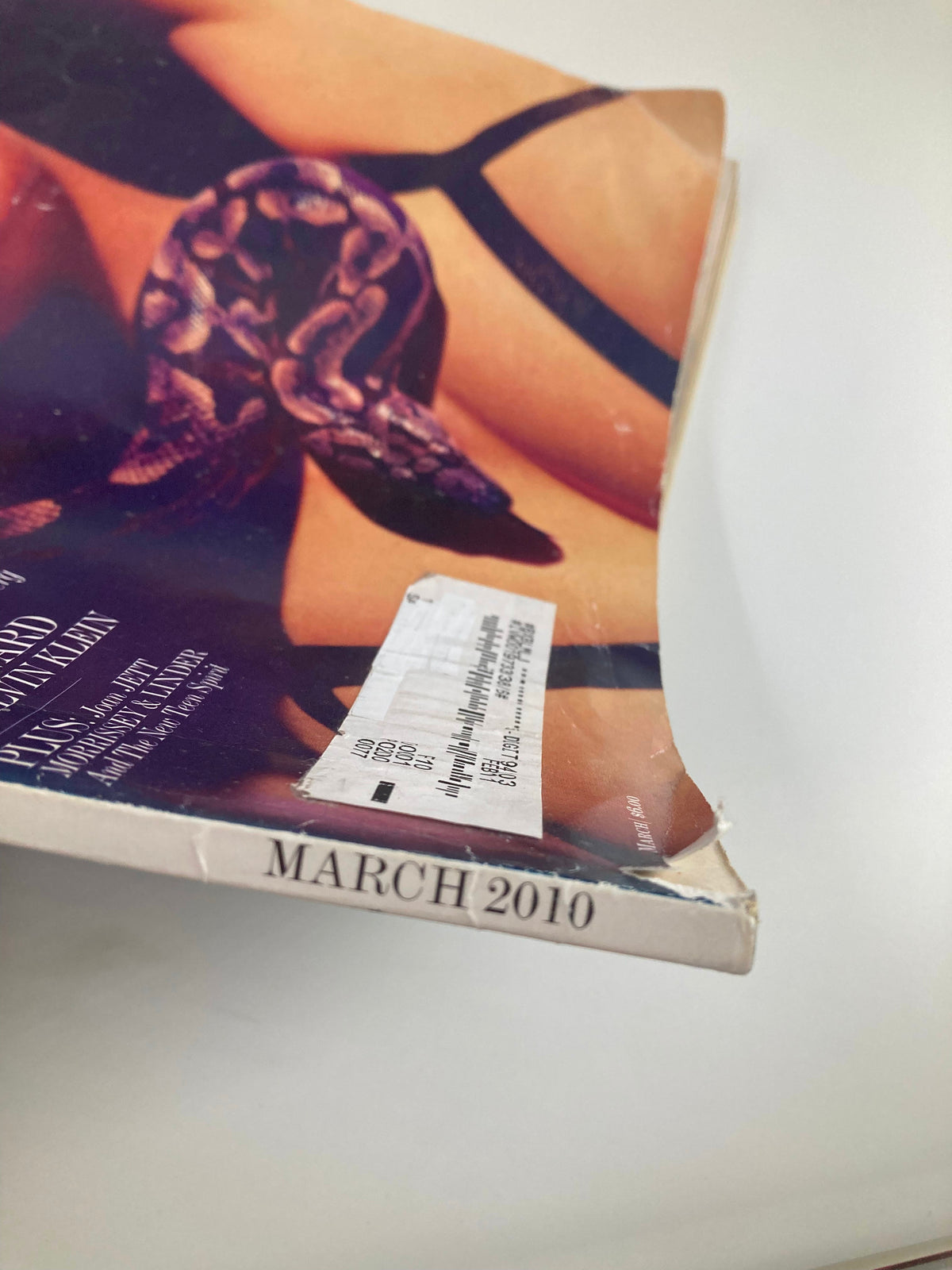 Cover of Interview Magazine March 2010 showing a damaged corner and a label on the front.