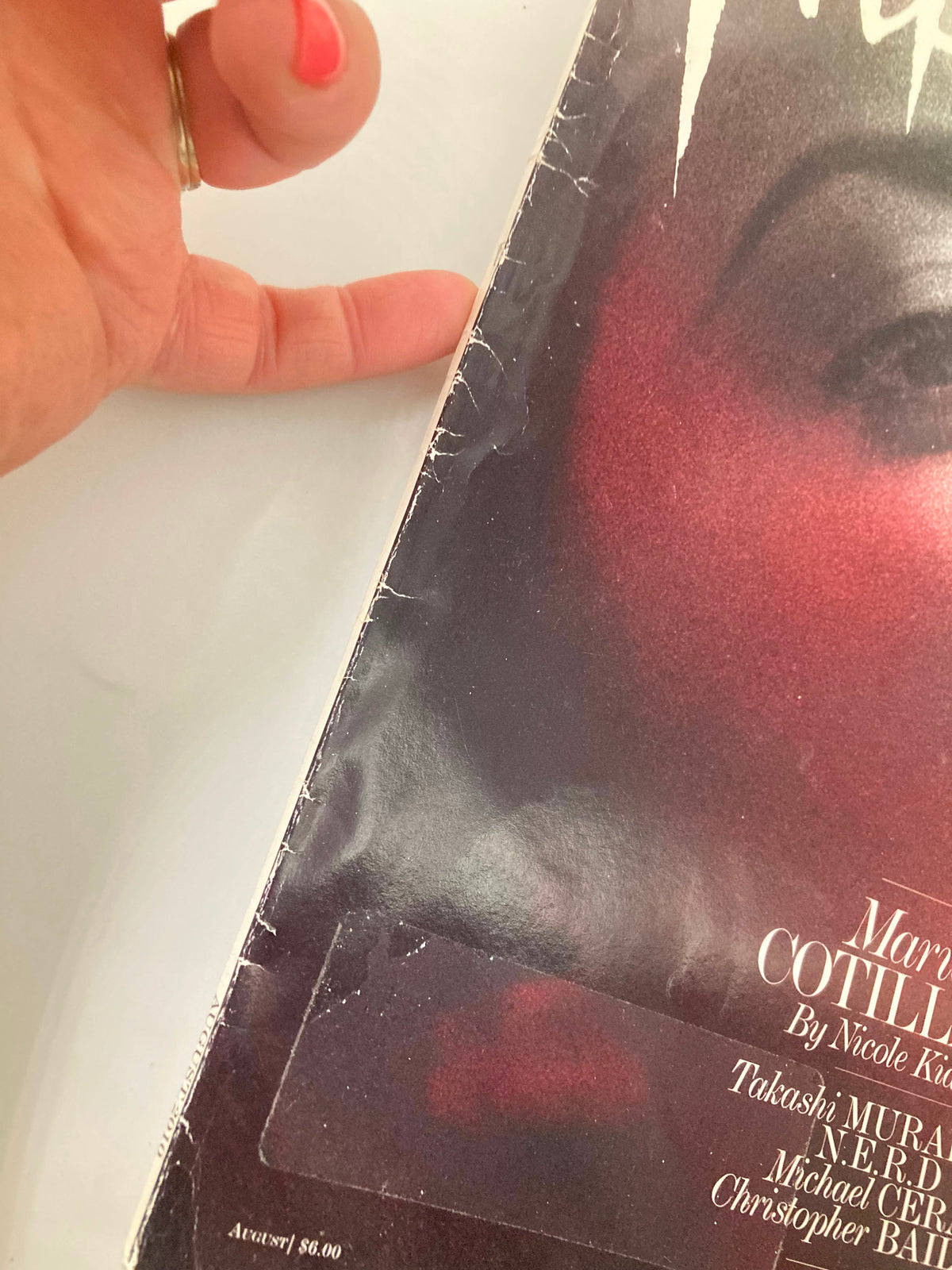 Close-up view of the August 2010 Interview Magazine featuring Marion Cotillard on the cover, showing minor wear and a price label, emphasizing its vintage charm.