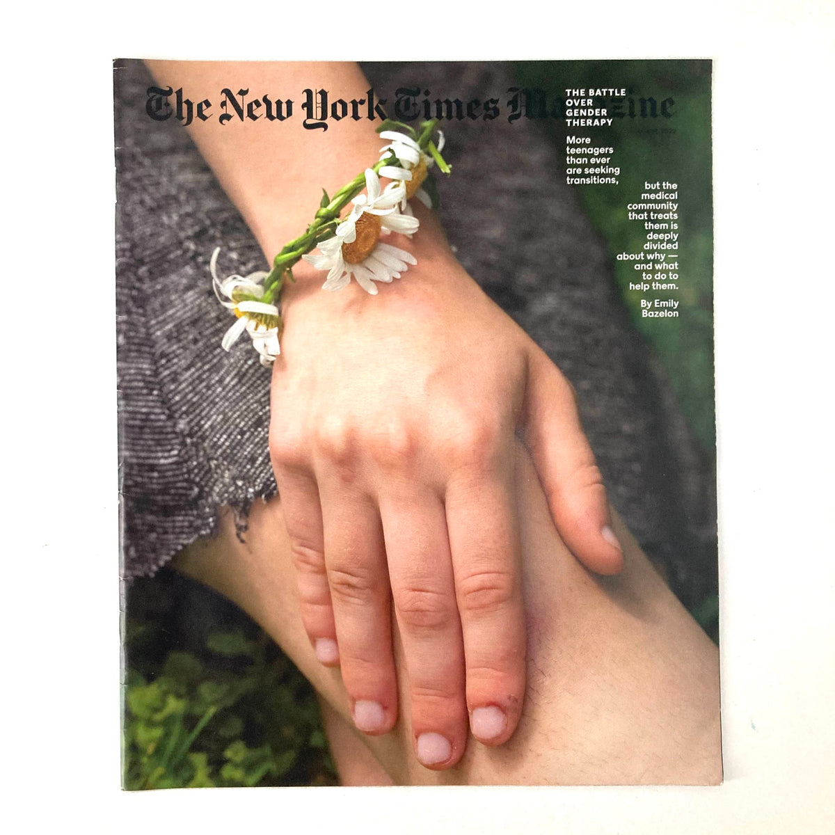 The New York Times Magazine June 19, 2022 cover featuring a close-up of a hand adorned with daisies, symbolizing themes of gender therapy and identity.