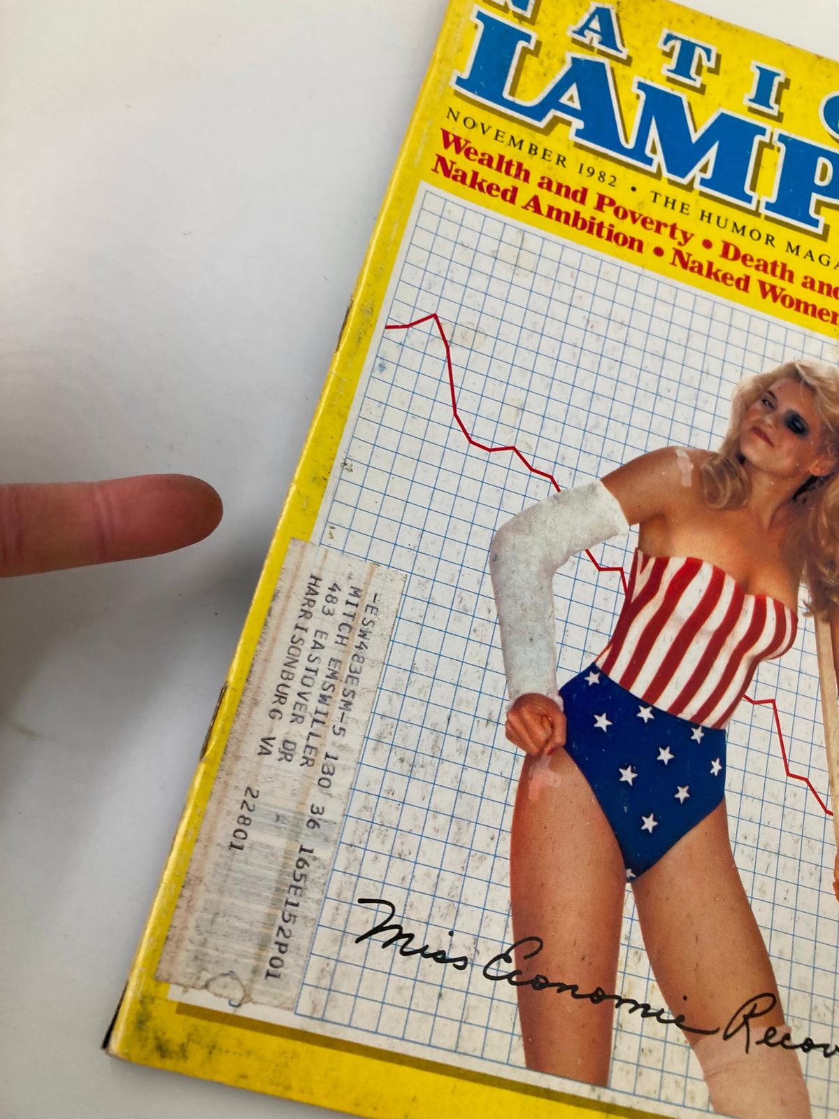 Close-up of the cover of National Lampoon Humor Magazine November 1982 highlighting 'Miss Economic Recovery'. The image also includes a partial view of the magazine's label and features a playful graphic design.
