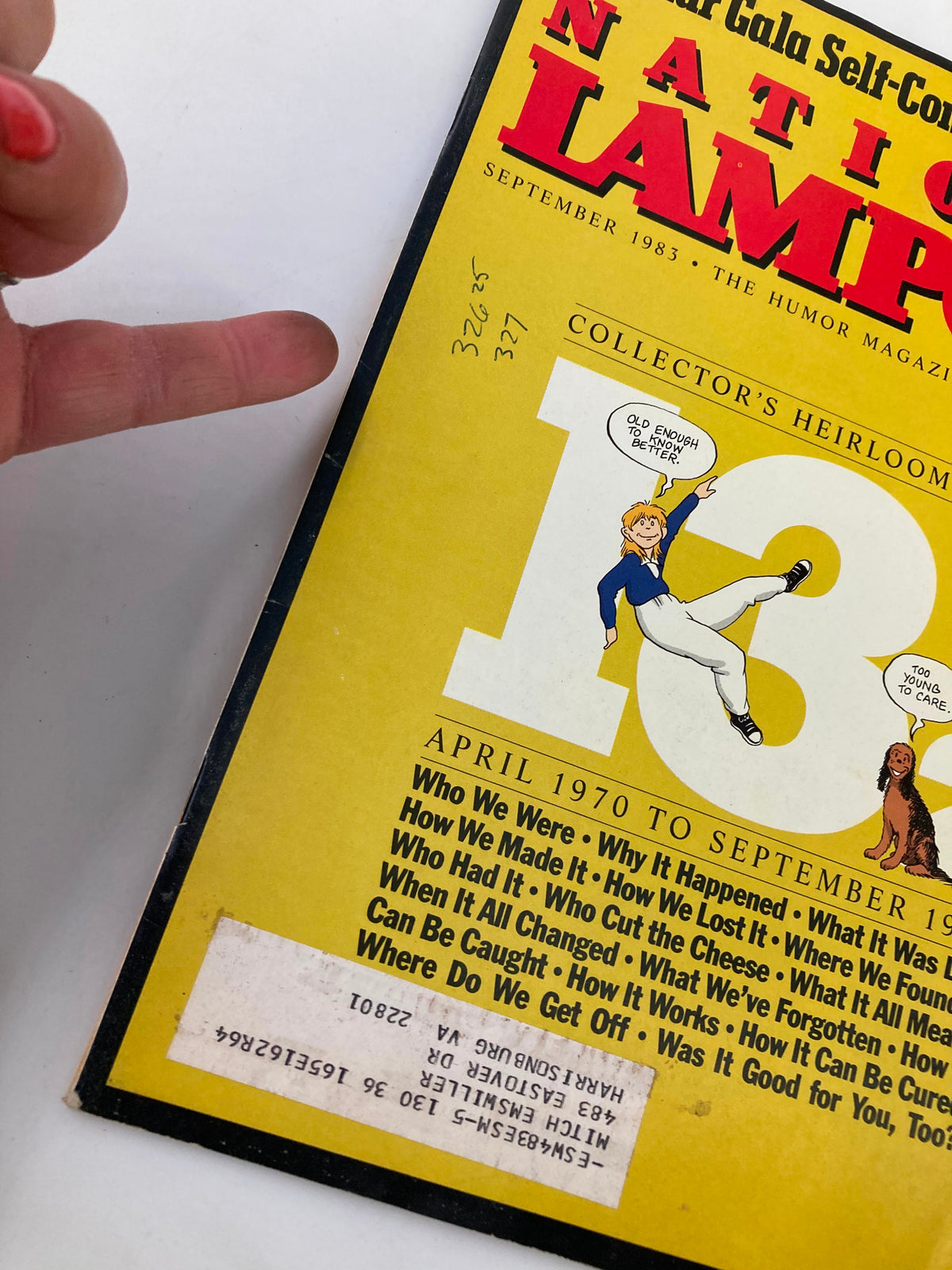 Close-up of the National Lampoon Humor Magazine September 1983 cover, showcasing the title and collector's heirloom details with a finger pointing to the content sections.