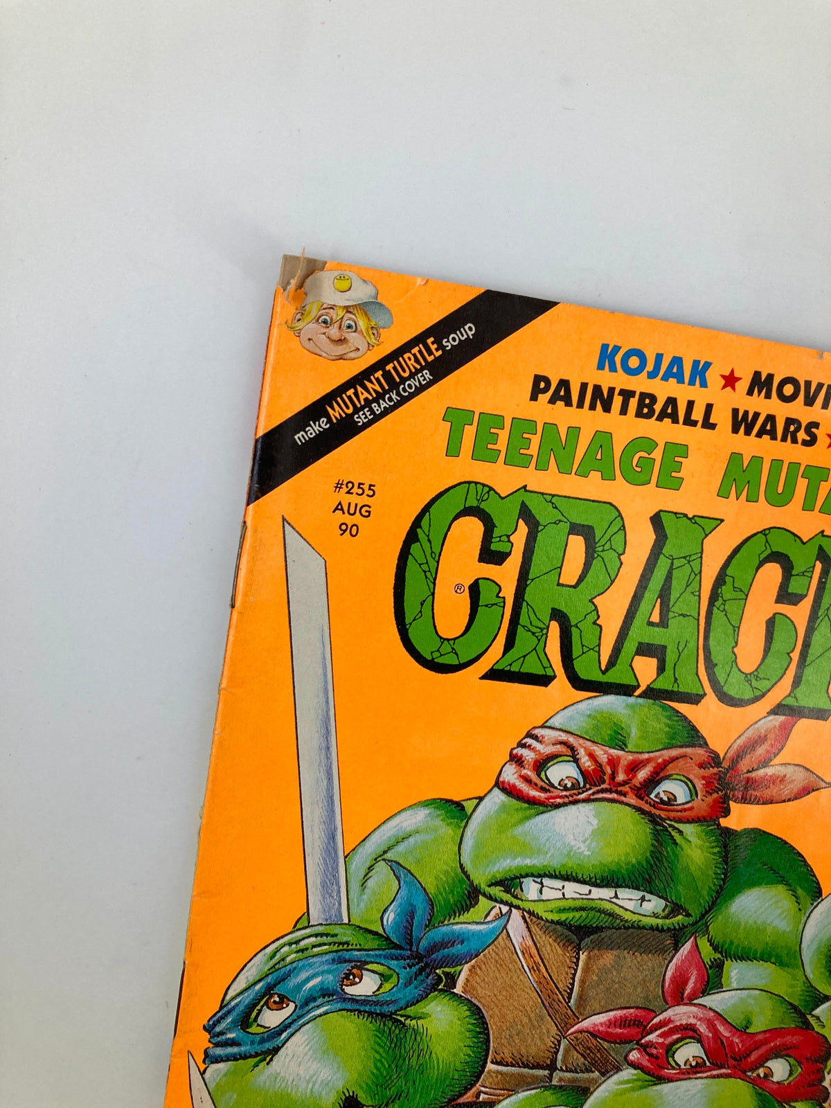 Close-up view of the top corner of Cracked Humor Magazine August 1990 showcasing Teenage Mutant Ninja Turtles. Features a humorous advertisement with a character promoting MUTANT TURTLE soup.