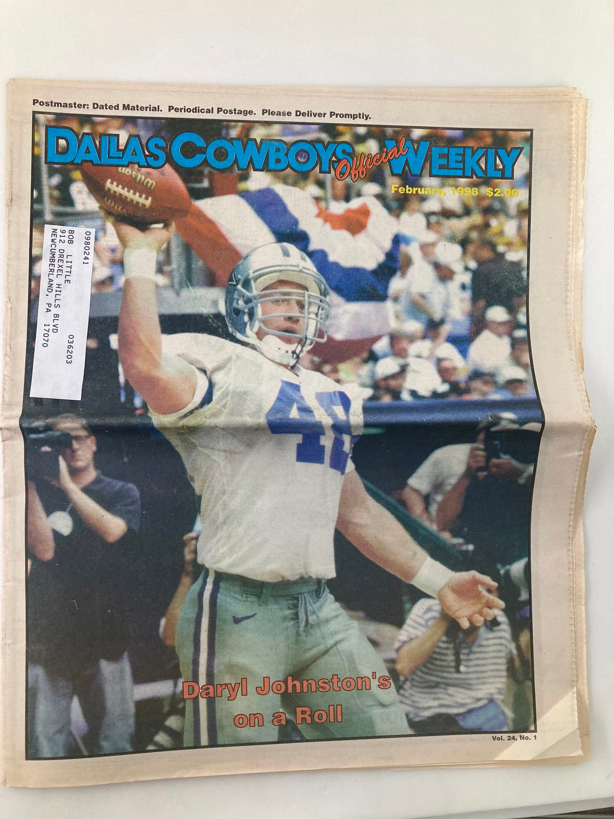 Cover of Dallas Cowboys Weekly Newspaper from February 1998, Volume 24, Number 1 featuring Daryl Johnston celebrating with raised arms on the field.