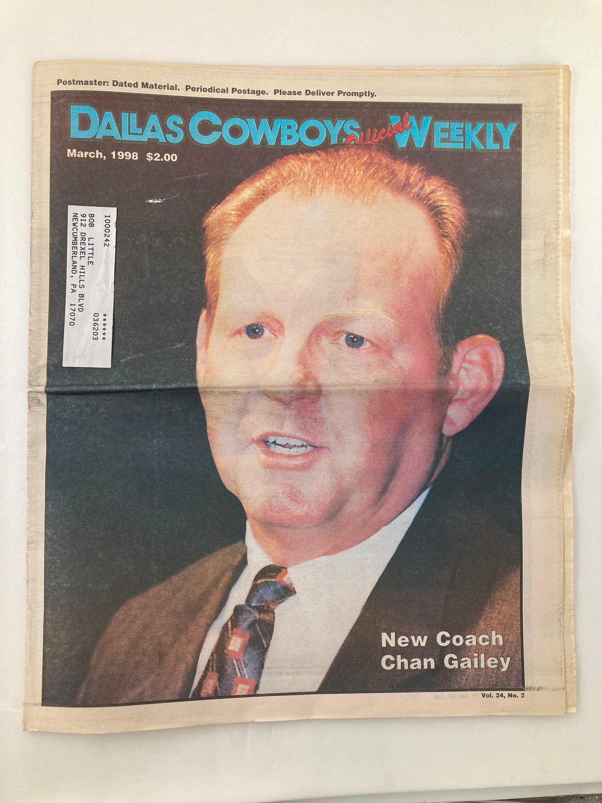 Dallas Cowboys Weekly Newspaper March 1998 Vol 24 #2 featuring new coach Chan Gailey, showcasing an image of him on the front cover. The publication is in good condition with minor wear and is folded, as indicated by the protective covering.