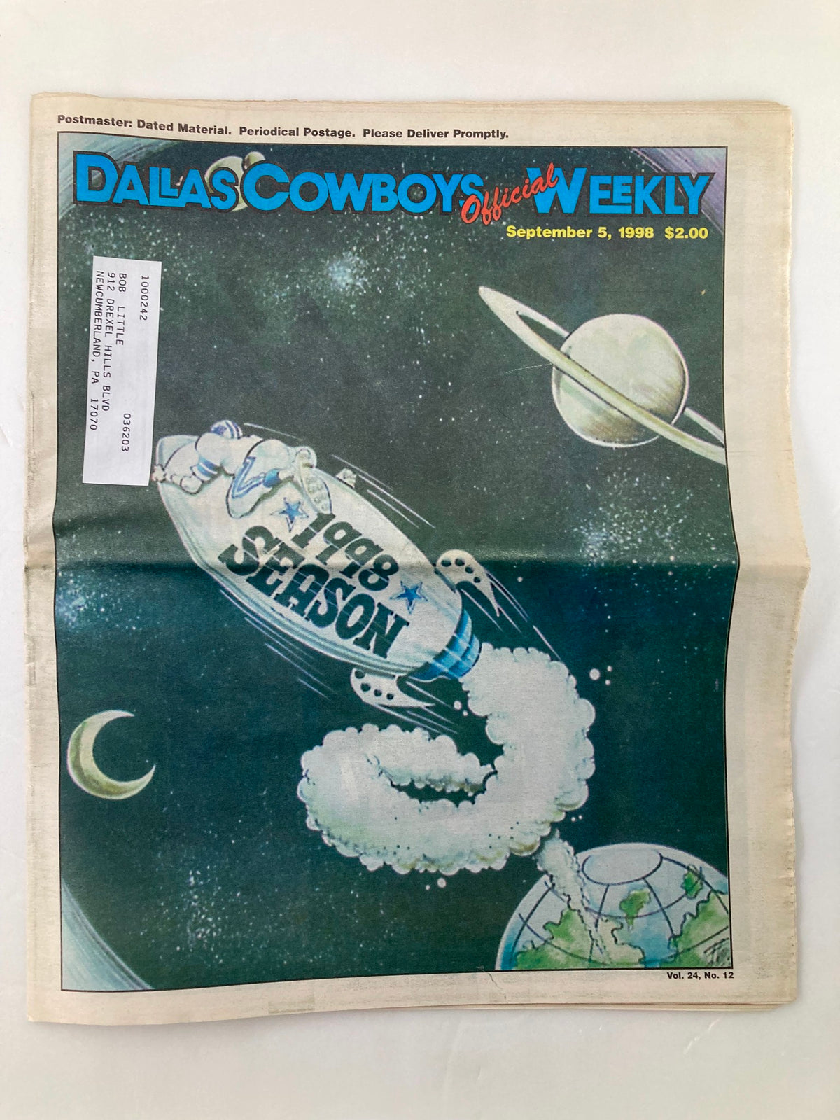 Front cover of the Dallas Cowboys Weekly Newspaper from September 5, 1998, Vol 24 #12 featuring an illustration of a rocket, symbolizing the 1998 season launch. The newspaper is in good condition with a minor wear, featuring a label on the front.