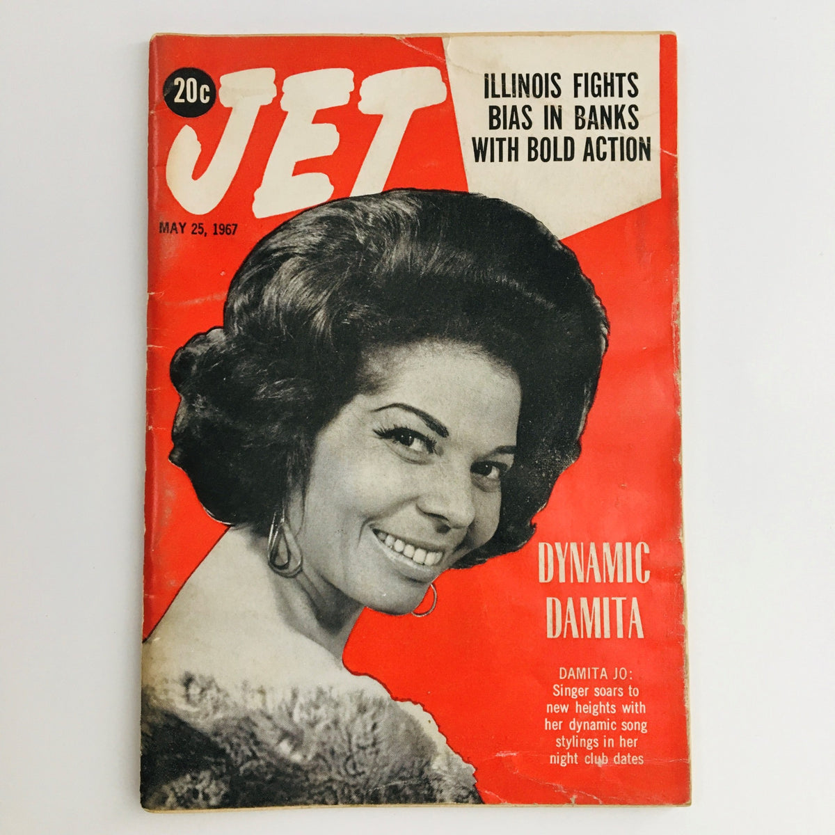 Jet Magazine May 25 1967 cover featuring dynamic singer Damita Jo, showcasing her charming smile and styled hair against a vibrant red background, highlighting the issue's title and themes of music and culture.