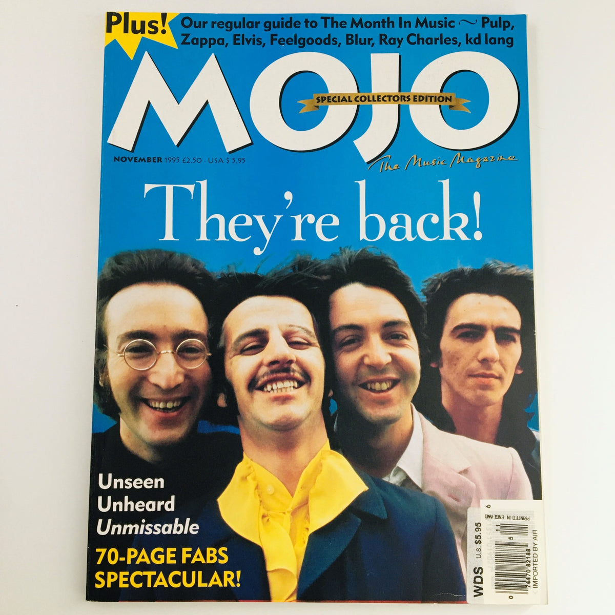 Mojo Magazine November 1995 Vol 24 #3 featuring The Beatles, with a vibrant blue cover showcasing smiling band members. Highlighted text reads 'They're back!' and mentions 'Unseen Unheard Unmissable'. A special collectors edition.