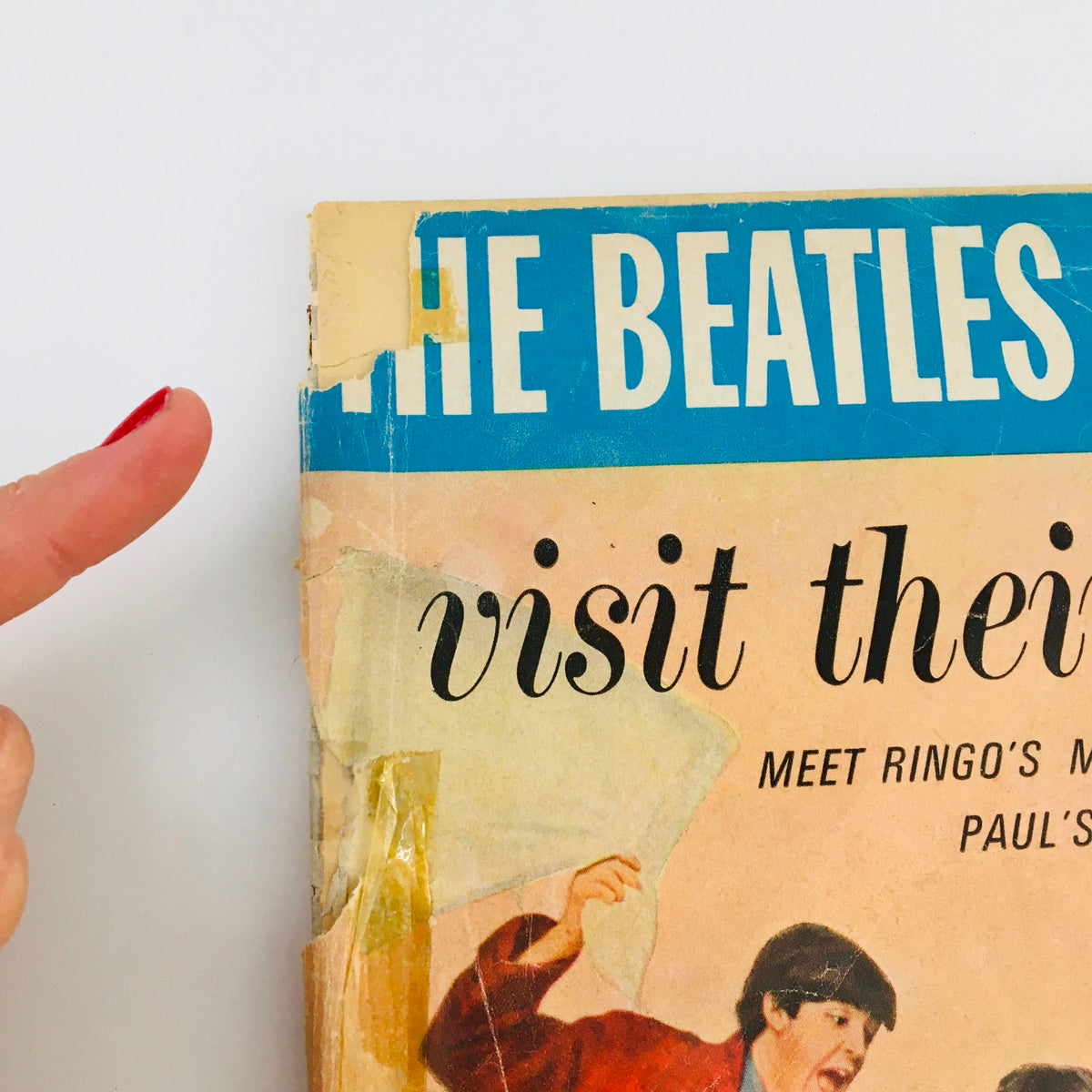 Close-up of the magazine cover of 1964 The Beatles Are Back and Visit Their Home, emphasizing the playful title and details around Ringo and Paul's characters.