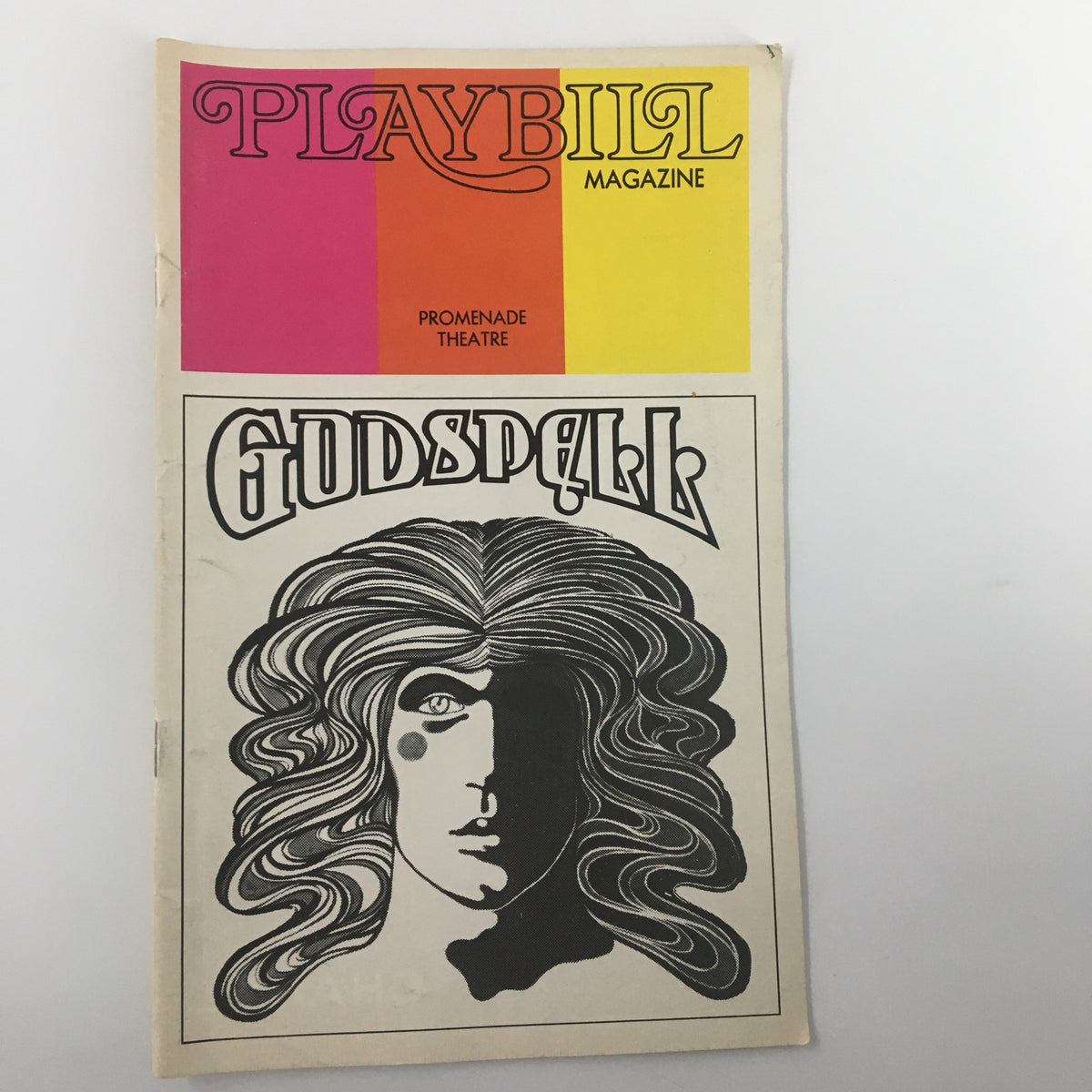 1973 Playbill for Godspell by John-Michael Tebelak featuring the cover artwork with a stylized face representing the musical.