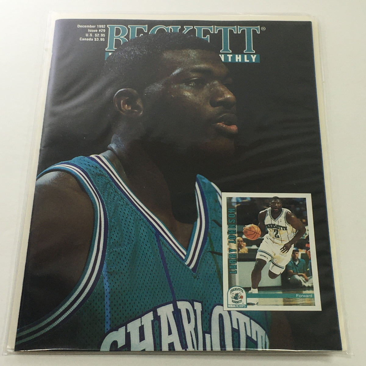Beckett Basketball Monthly December 1992 Issue #29 featuring Larry Johnson on the cover with a close-up portrait, showcasing his Charlotte Hornets jersey and an accompanying photo card.
