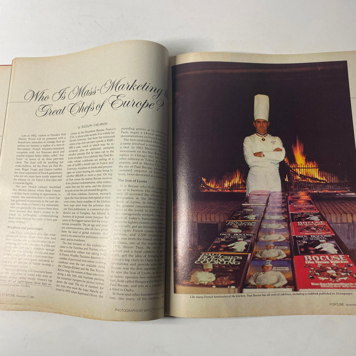 Two-page spread in Fortune Magazine, November 17, 1980, featuring a chef standing proudly in front of a large fireplace surrounded by culinary books. The article discusses the rise of French chefs and their influence on gastronomy.