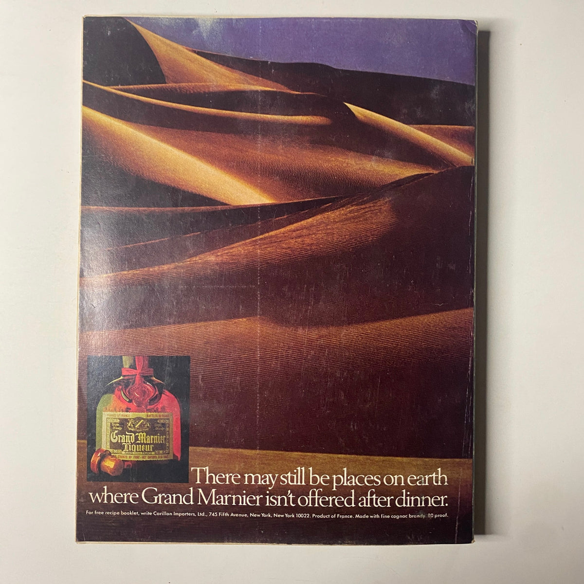 Back cover of Forbes Magazine September 15, 1977 featuring a striking desert landscape with a Grand Marnier advertisement, showcasing the phrase 'There may still be places on earth where Grand Marnier isn't offered after dinner.' This vintage magazine highlights the celebration of sixty years of American business.
