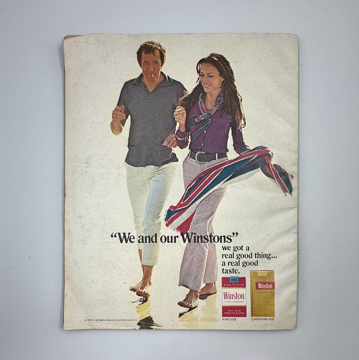 Advertisement page from Holiday Magazine October 1969 featuring a couple promoting Winstons cigarettes, showcasing a casual lifestyle.