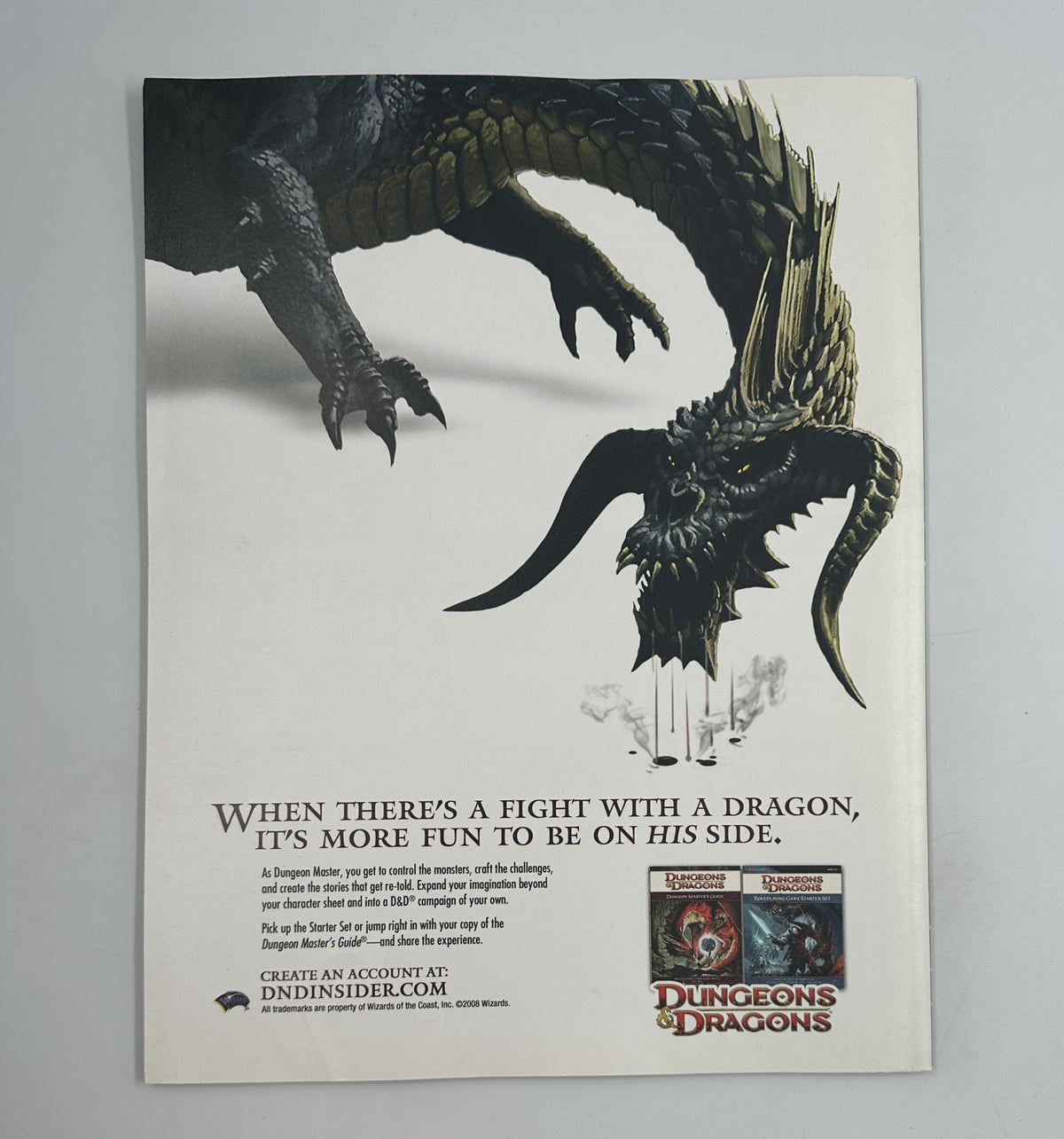 Promotional advertisement for Dungeons and Dragons, highlighting a dragon and inviting users to create an account on dndinsider.com.