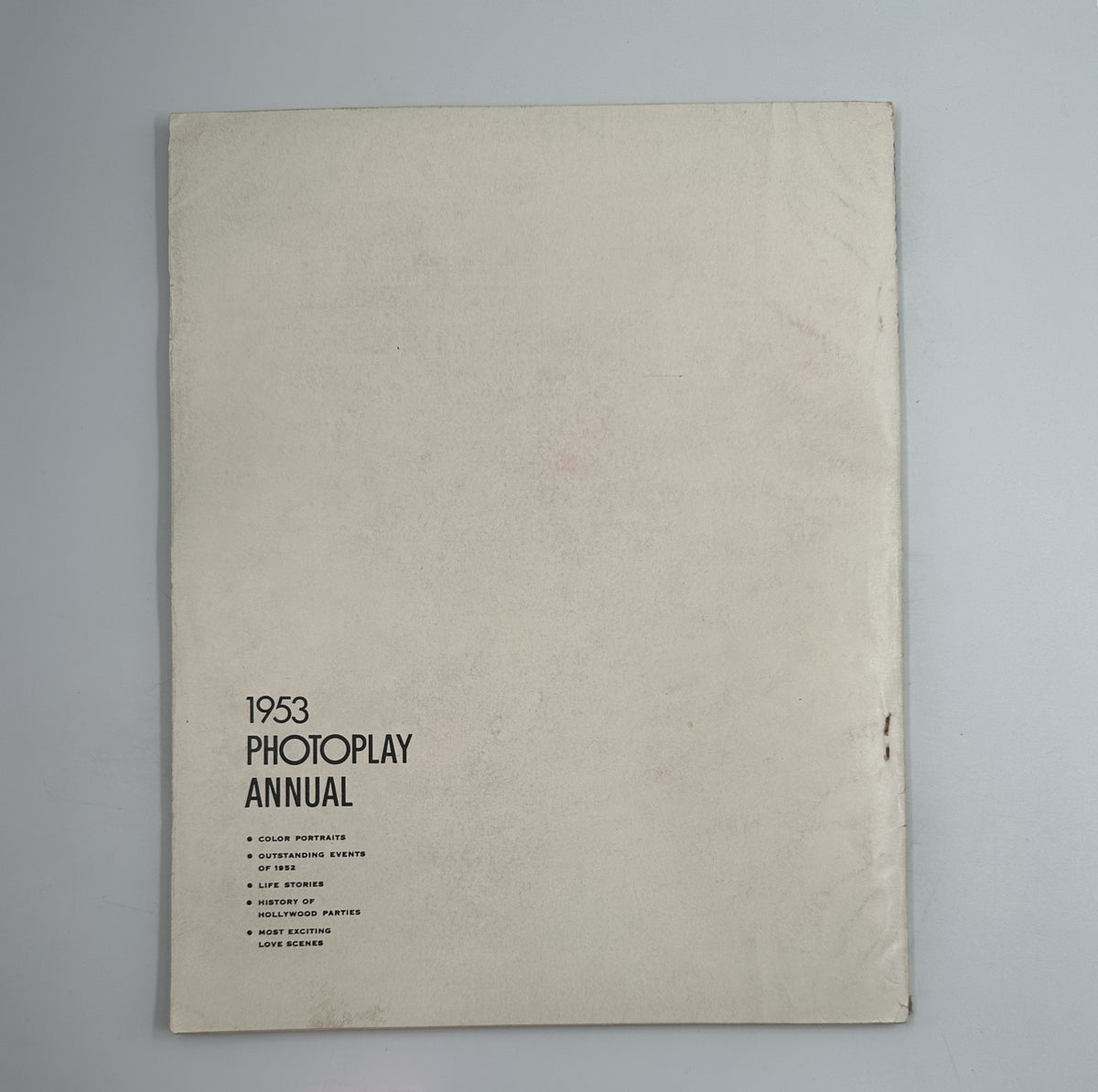 The back cover of the 1953 Photoplay Annual Magazine, featuring a minimalist design with the title, '1953 Photoplay Annual,' and a list of contents including features and highlights of the magazine.