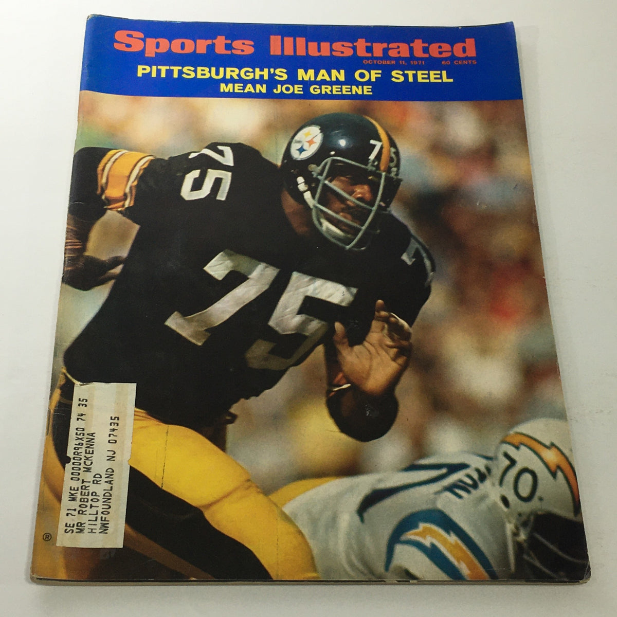 Cover of Sports Illustrated: October 11, 1971 featuring Joe Greene, Pittsburgh's Man of Steel, showcasing a dynamic image of Greene in action on the football field, wearing jersey number 75.