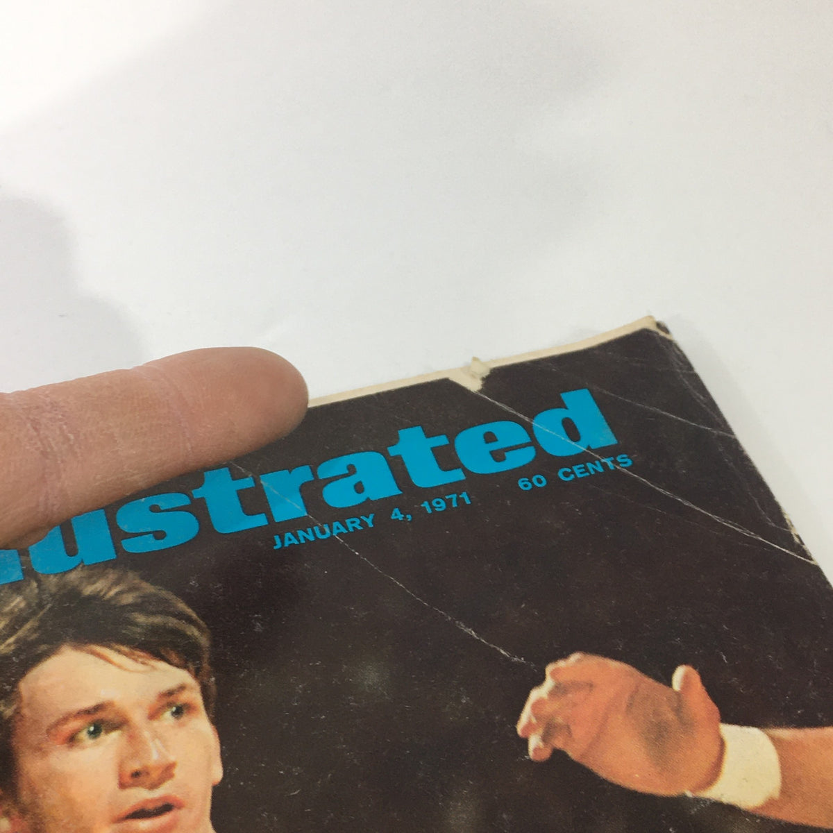Close-up detail of the cover of Sports Illustrated, January 4, 1971, highlighting the date and title featuring John Roche, with visible wear indicating its vintage status.