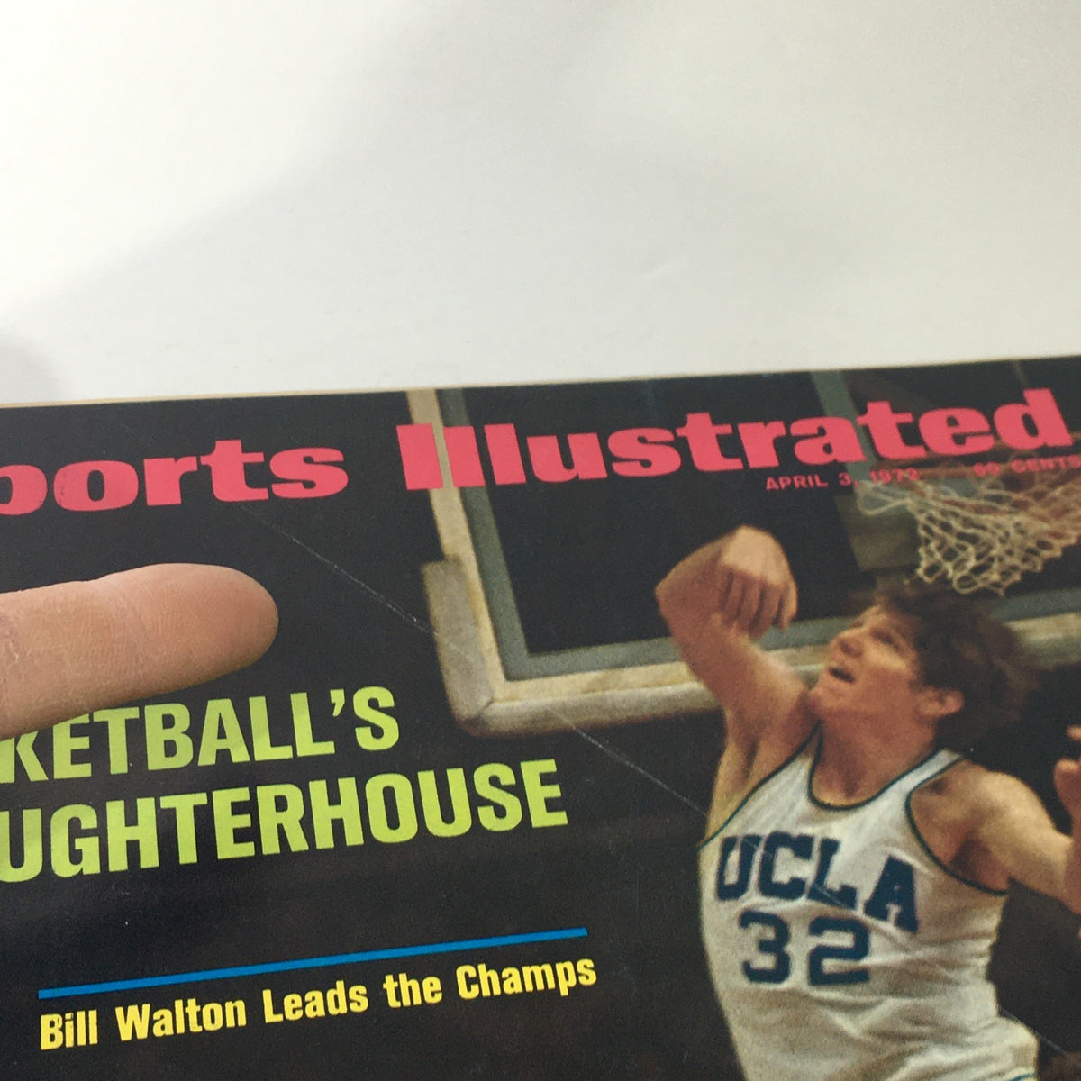 Cover of Sports Illustrated: April 3, 1972, featuring Bill Walton leading the champs, showcasing vibrant graphics and the headline 'Basketball's Slaughterhouse' along with an image of Walton in a UCLA jersey.