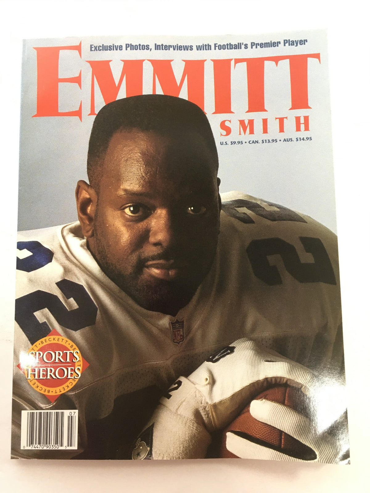 Beckett Sports Heroes: 1996 - Exclusive: Emmitt Smith Football magazine cover featuring Emmitt Smith, showcasing exclusive photos and interviews with the football star. The cover displays a striking image of Smith wearing a white jersey, holding a football, and includes pricing details and the Beckett Sports Heroes logo.