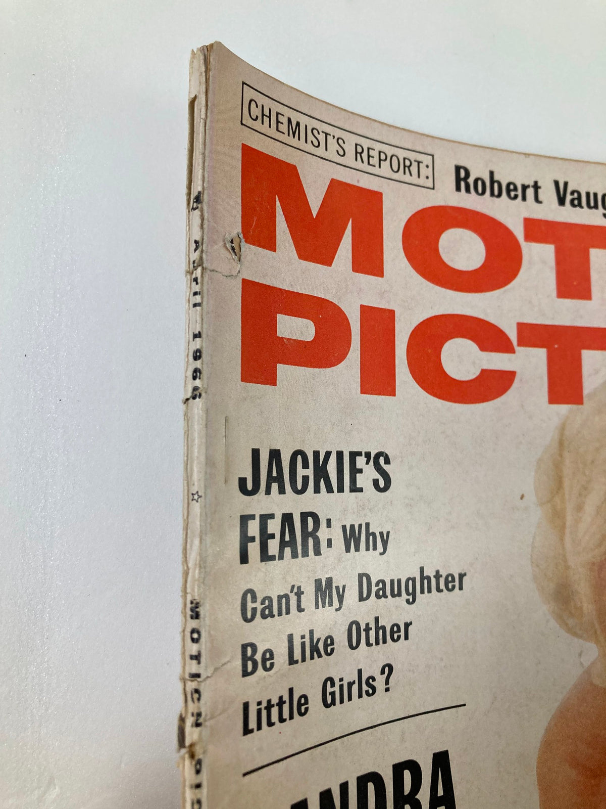 Side view of the VTG Motion Picture Magazine April 1966, displaying magazine title and wear, focusing on classic cinema nostalgia.