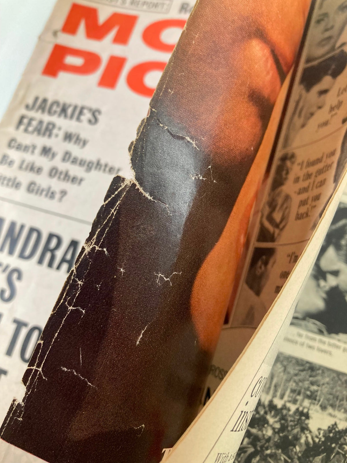 Interior view of the VTG Motion Picture Magazine April 1966 showing page damage and classic advertising, emphasizing vintage collectible condition.