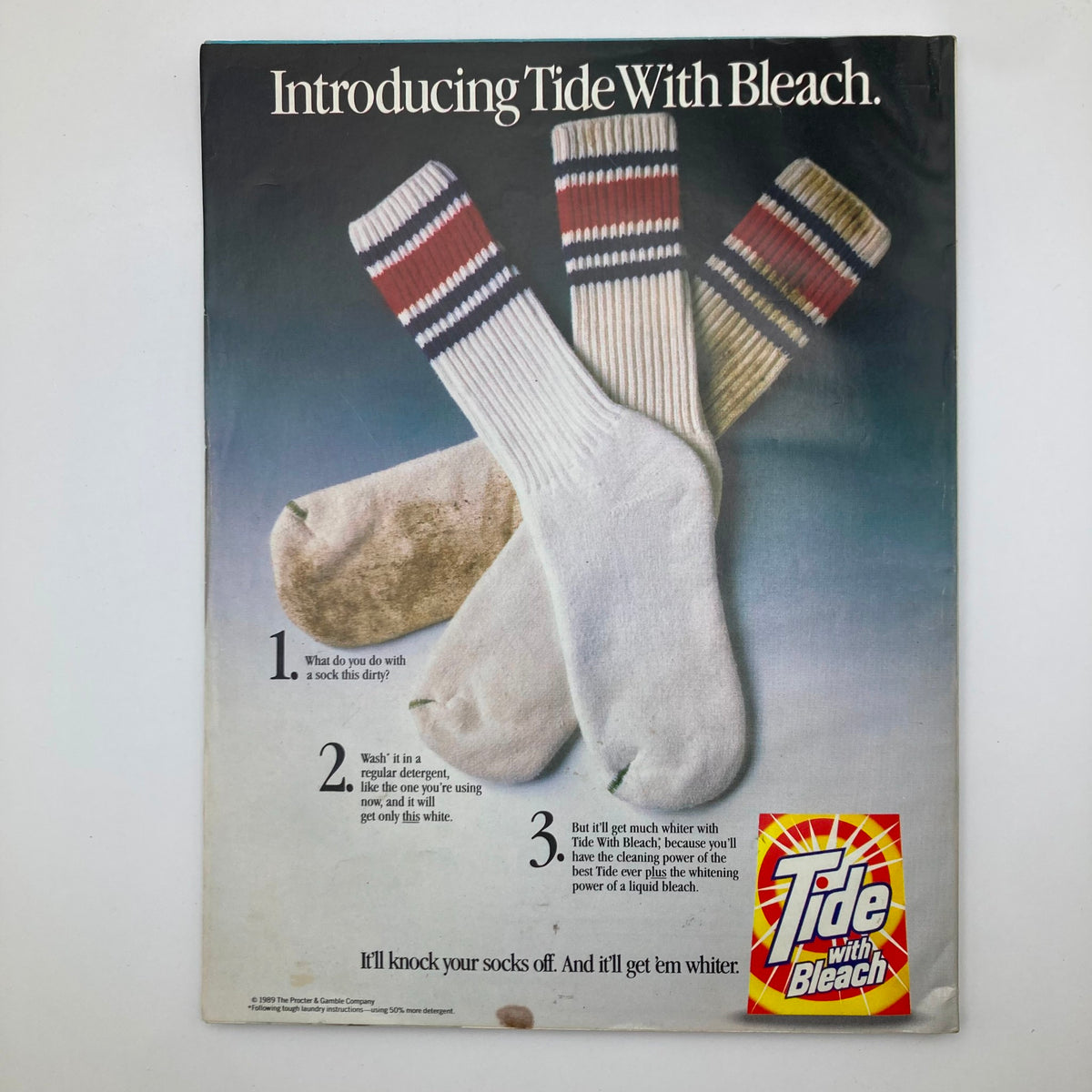 Advertisement page from Ladies' Home Journal August 1989 promoting Tide with Bleach, featuring dirty and cleaned socks to illustrate the product's effectiveness.