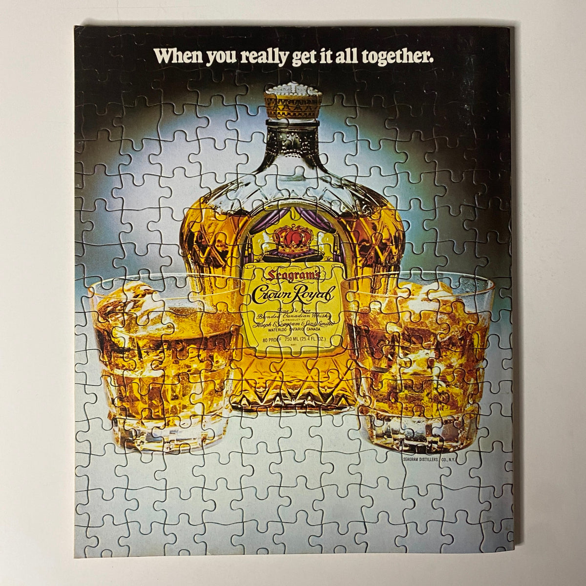 Image of a vintage puzzle featuring a Crown Royal whiskey bottle and two glasses filled with whiskey, accompanied by the text 'When you really get it all together' from Fortune Magazine's July 2, 1979 issue titled 'Television's Widening World'.