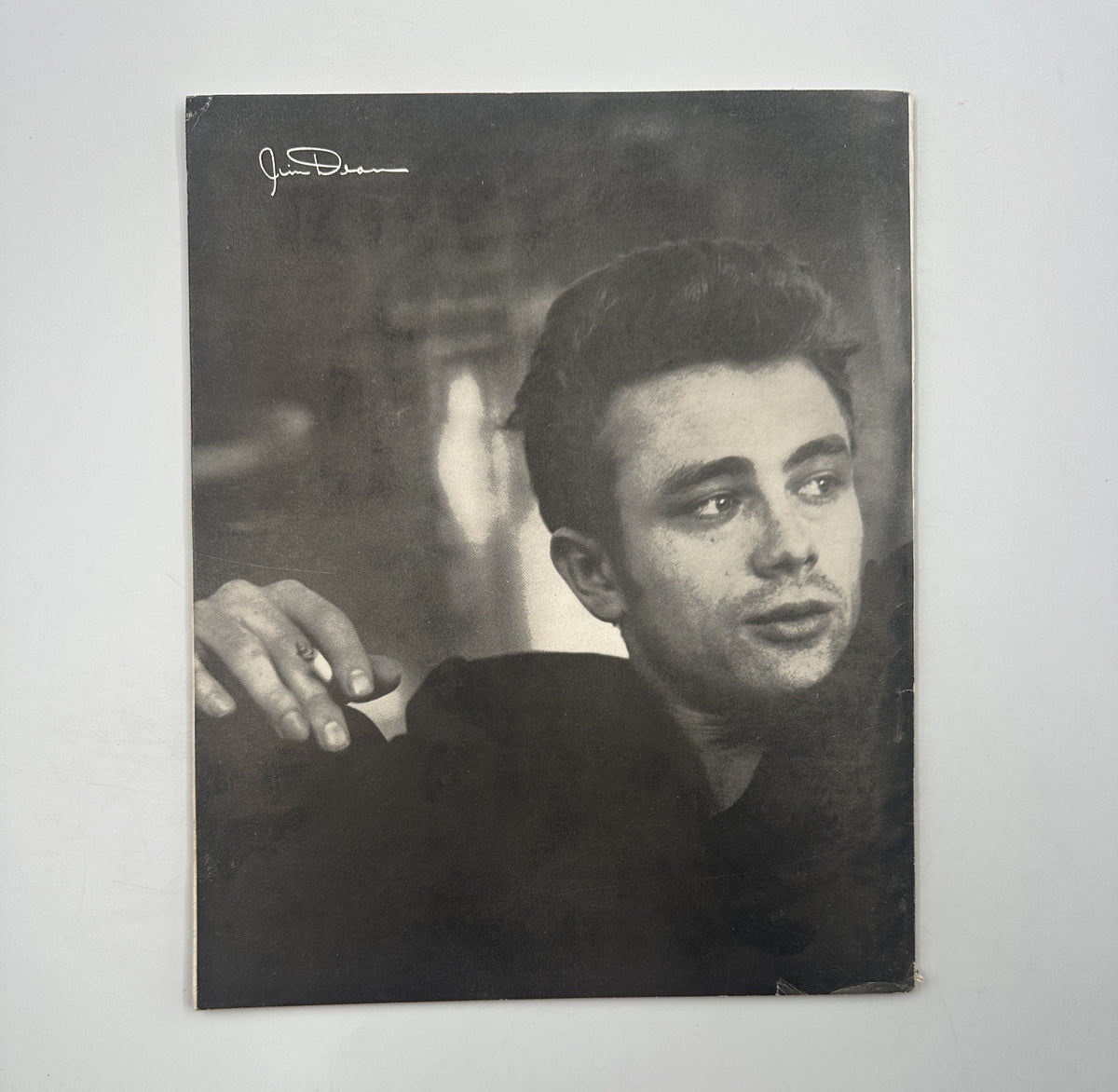 James Dean Anniversary Book Magazine 1956 Official Dell featuring a portrait of James Dean, depicting his iconic style and charisma in a black and white photograph. This collectible magazine showcases the actor's legacy and accomplishments.