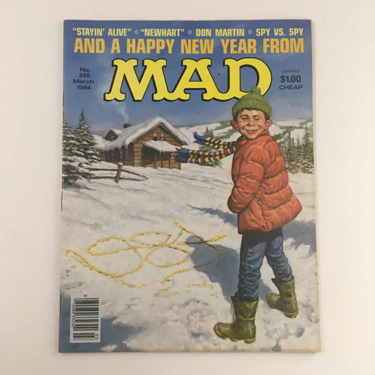 Cover of Mad Magazine March 1984 No. 245 featuring a boy in winter wear celebrating the New Year with snow and trees in the background. Fine condition, nostalgic representation of 1980s humor.