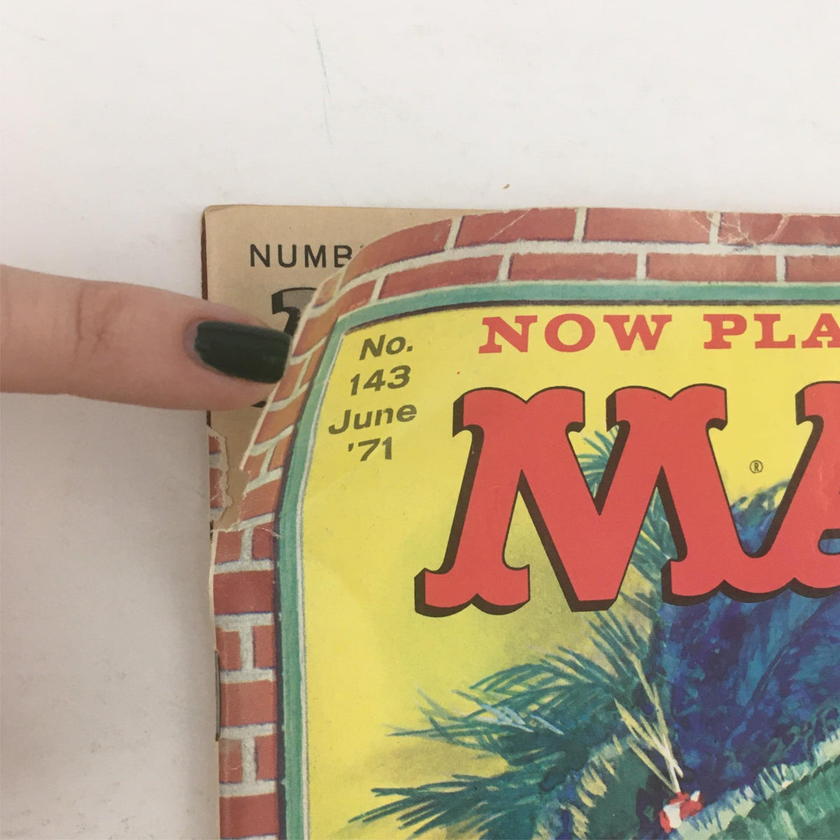 Close-up of the top corner of Mad Magazine June 1971 No. 143, showing the magazine number and publication date on a colorful background.