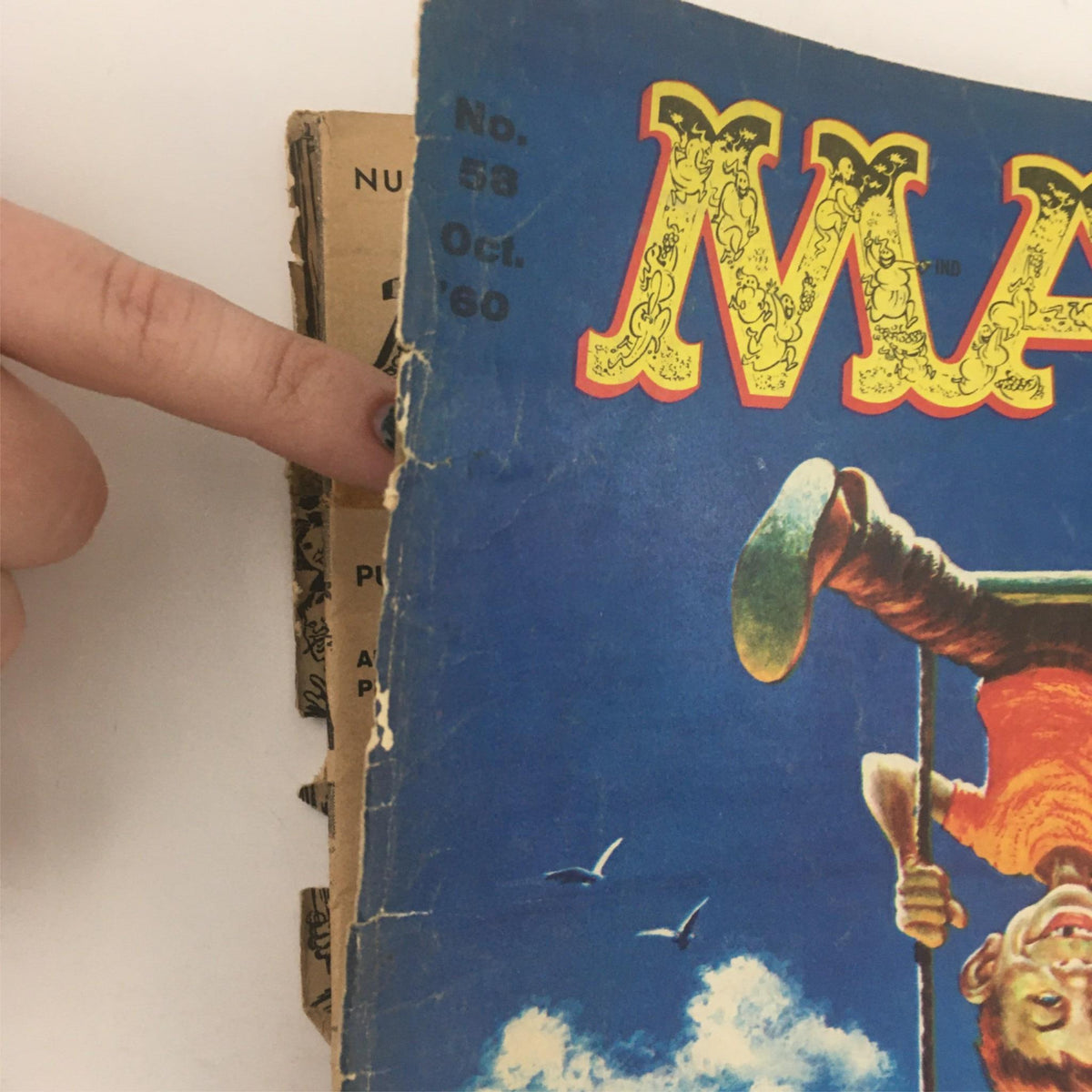 Close-up view of the spine of Mad Magazine October 1960 No. 58, highlighting the issue number and date, with visible wear that signifies its vintage status.