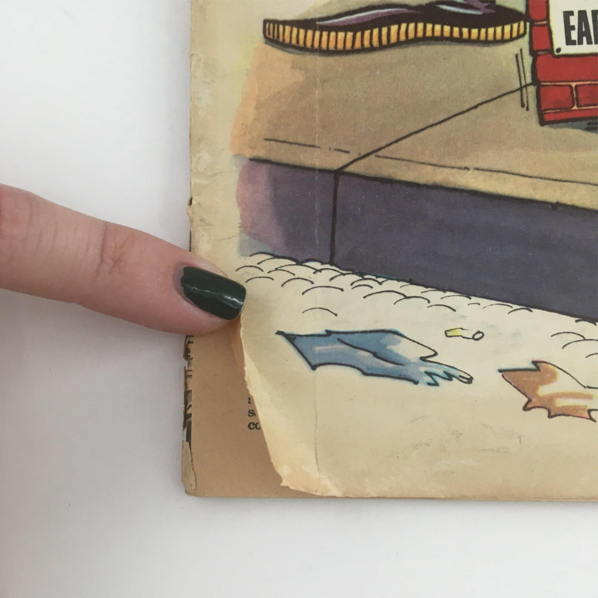 Close-up view of the corner of Mad Magazine January 1962 No. 68 'Season's Greetings x Santa,' highlighting wear and tear, showcasing the vintage condition of this collectible. Perfect for enthusiasts of classic comic history.