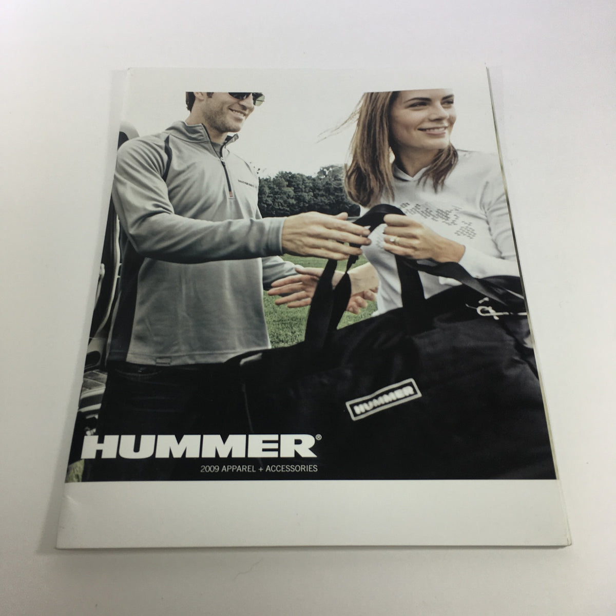 Cover of the 2009 Hummer Apparel and Accessories Brochure Catalog featuring a man and woman holding a black duffel bag.
